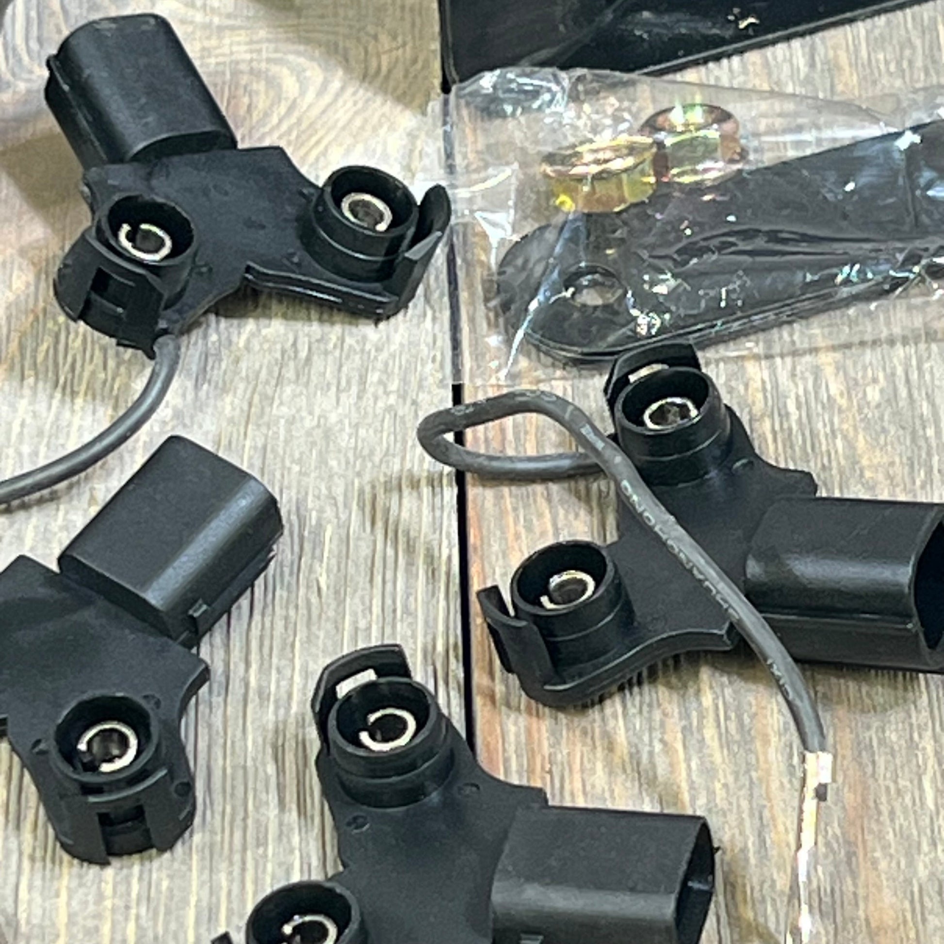 Black car horn components for Honda Civic and Acura, featuring wiring and connectors on a wooden surface.