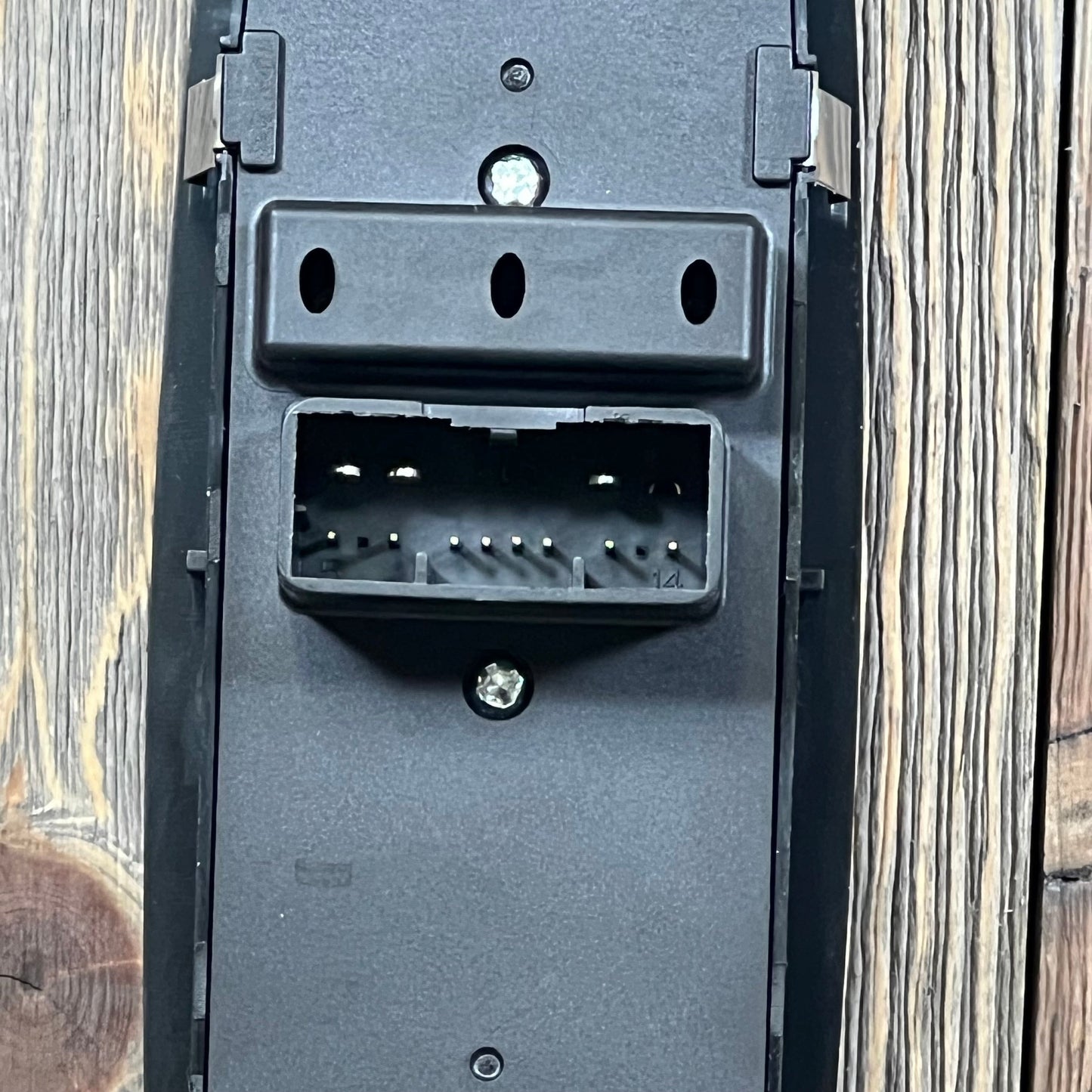 Close-up of the connector side of a master power window switch for Chrysler 300, 200, Dodge Charger, and Ram models.