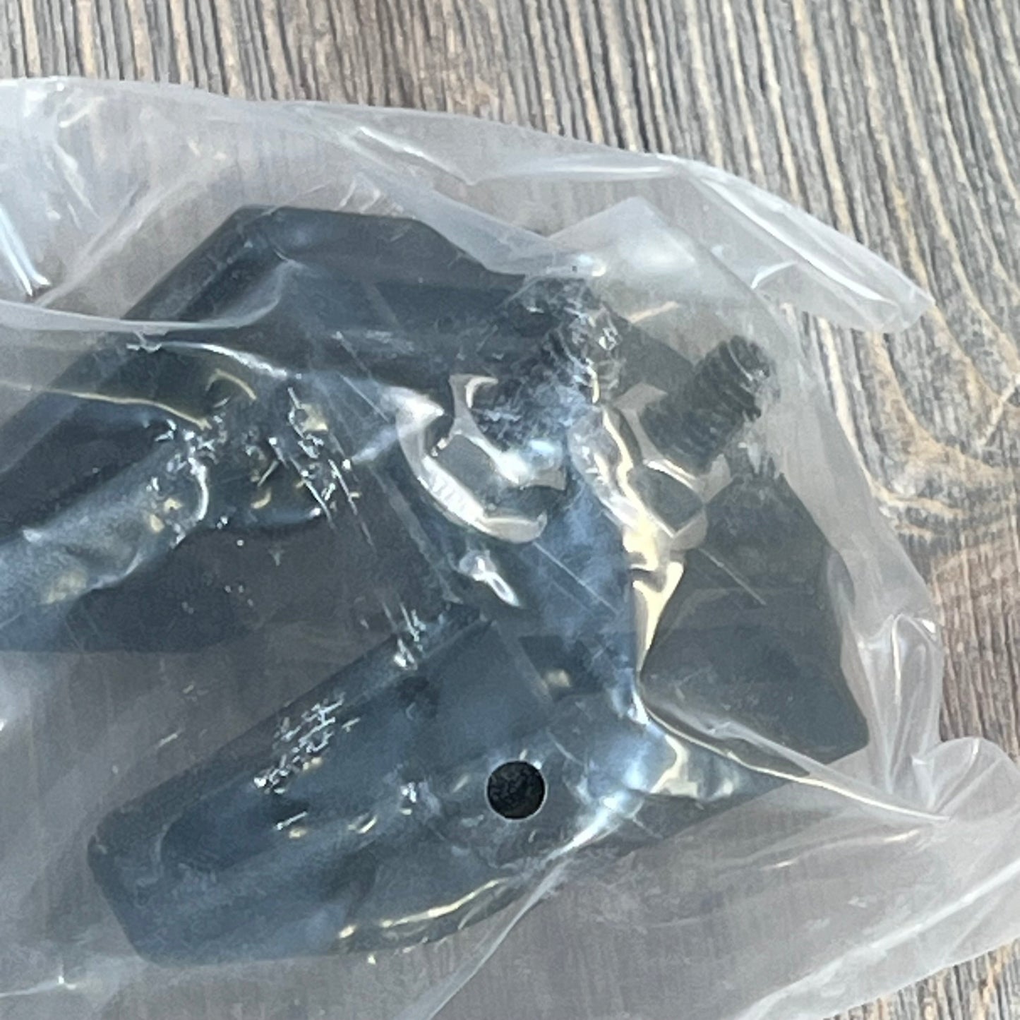Factory style black hood latches for Jeep Wrangler TJ 1997-2006, packaged in plastic, on a wooden surface.
