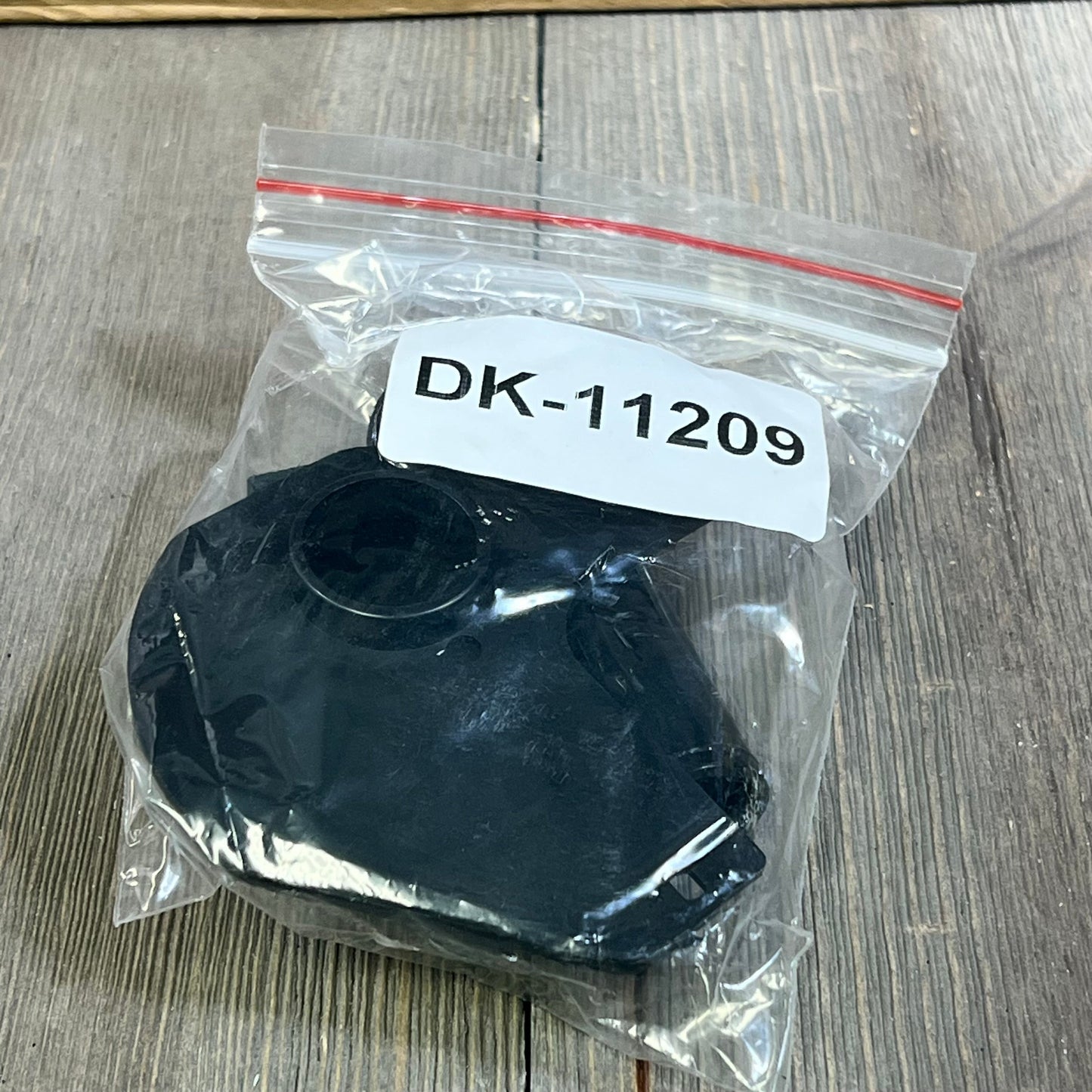 Black plastic frame for Aegis Adhesives DK-1209 label replacement in clear packaging, suitable for Brother QL printers.