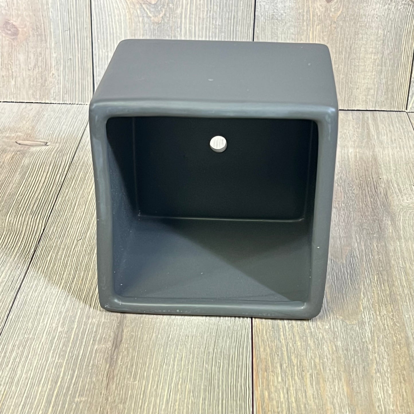 Modern black ceramic square plant pot on wooden floor, ideal for small succulents, part of a decorative set of 2 planters.