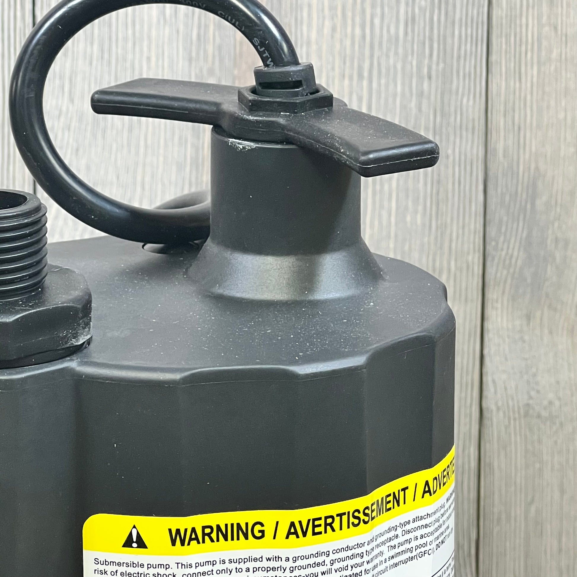 Close-up of the Acquaer 1/6 HP submersible water pump, showing the sturdy thermoplastic construction and warning label.