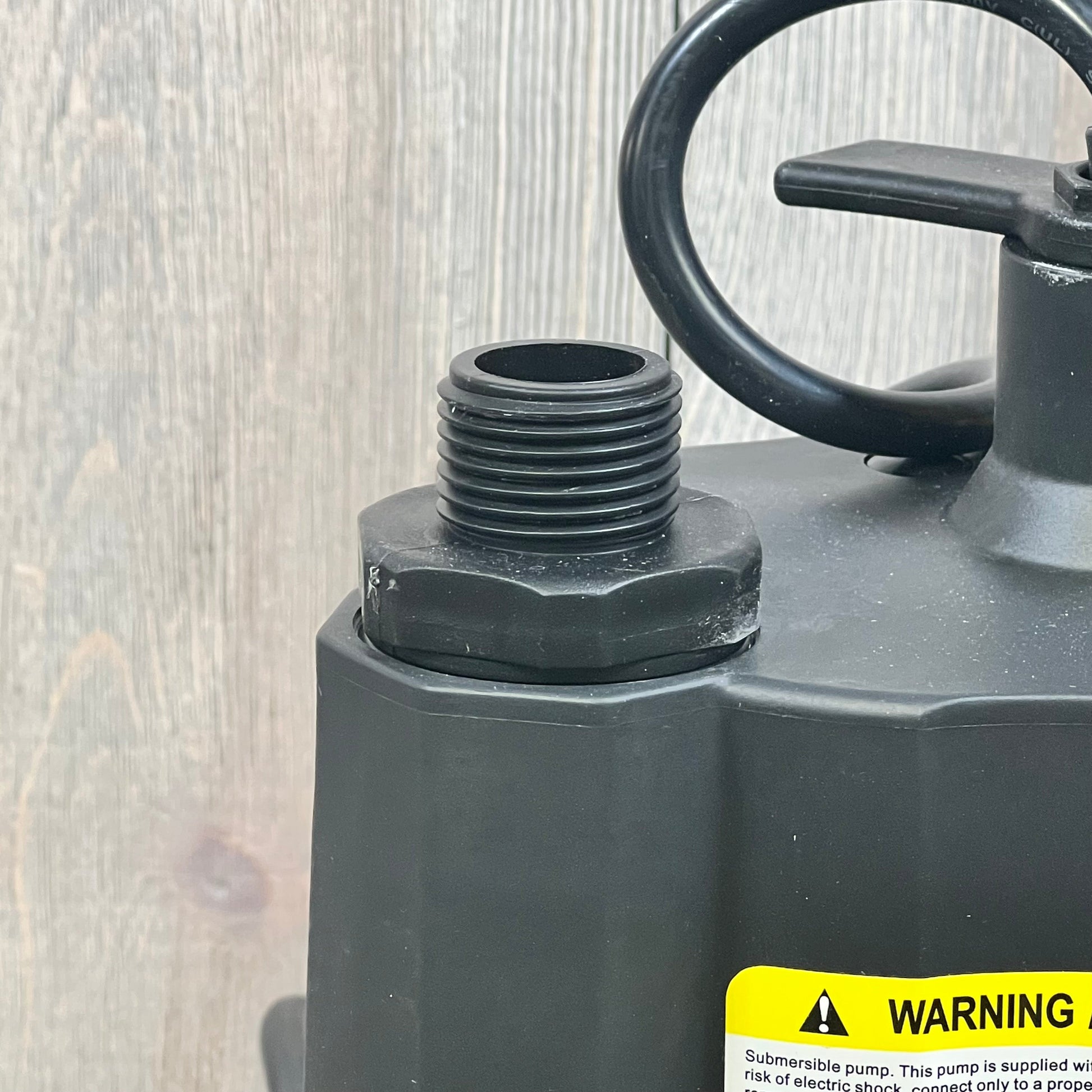 Acquaer submersible water pump close-up, showcasing durable thermoplastic construction and hose connection.