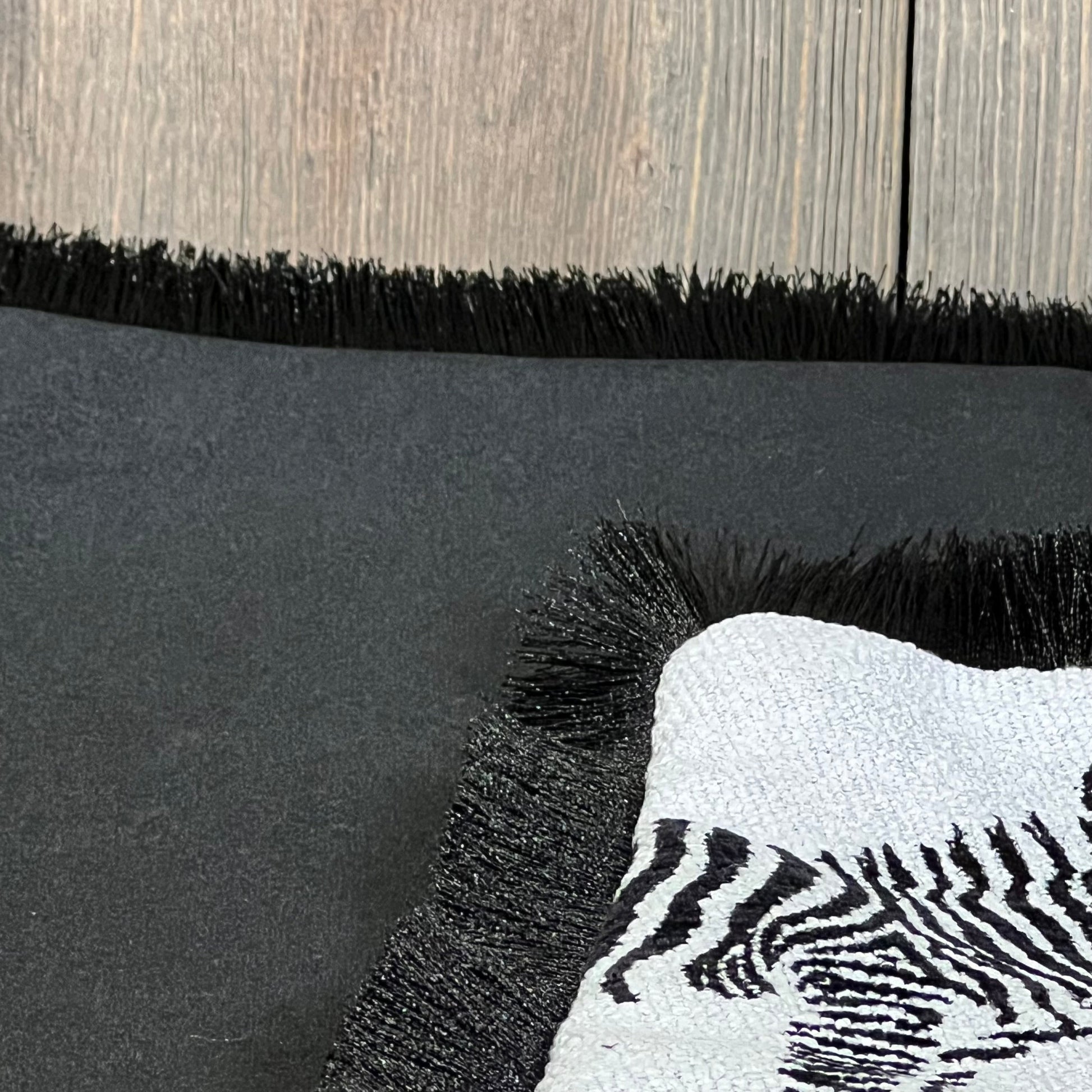 Luxury zebra-patterned throw pillow cover with black fringe, perfect for modern living room decor.