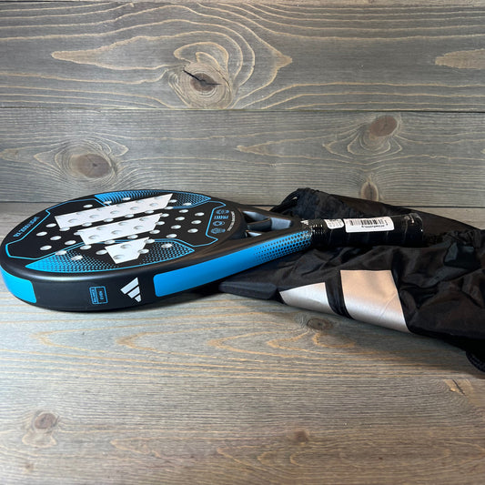 Blue Adidas Rx 2000 Light padel racket with sleek design, placed on a wooden surface, ideal for enhancing your game.