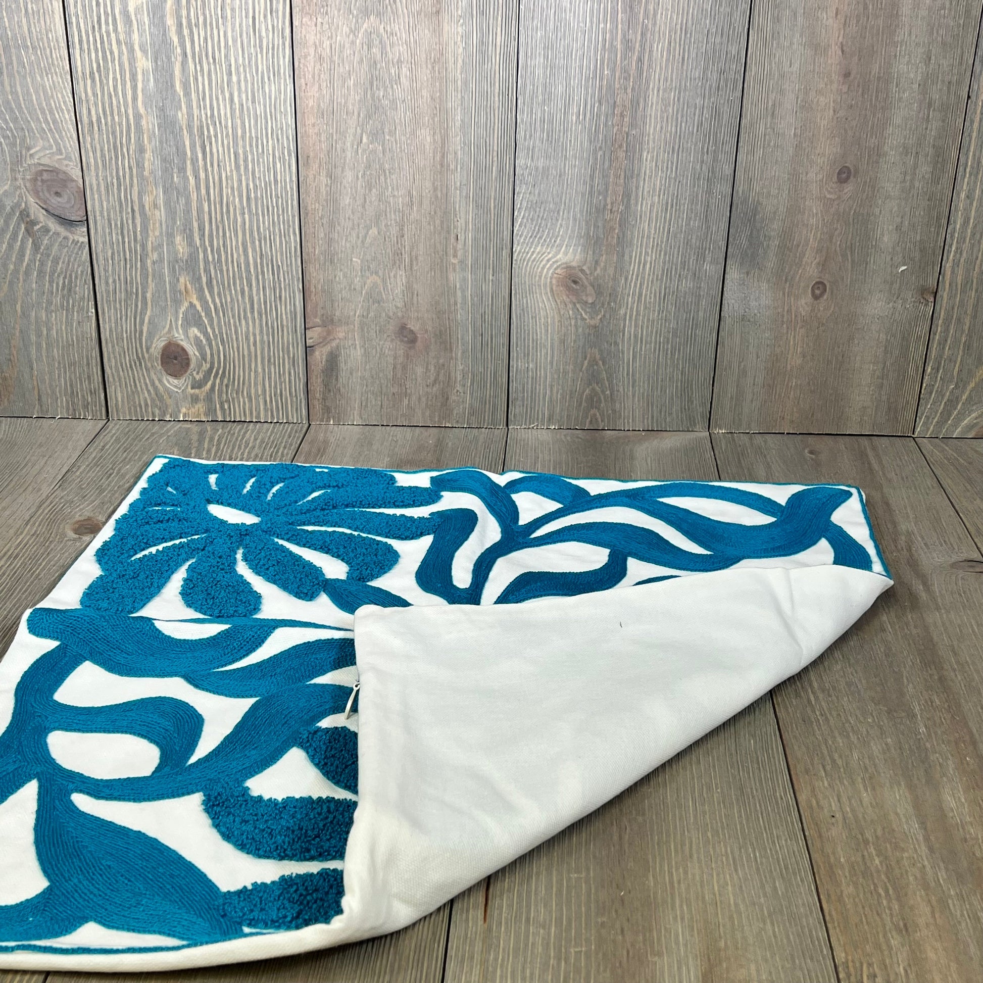 Teal blue Alysheer throw pillow cover with floral embroidery, showcasing intricate boho tufted leaves on cotton fabric.