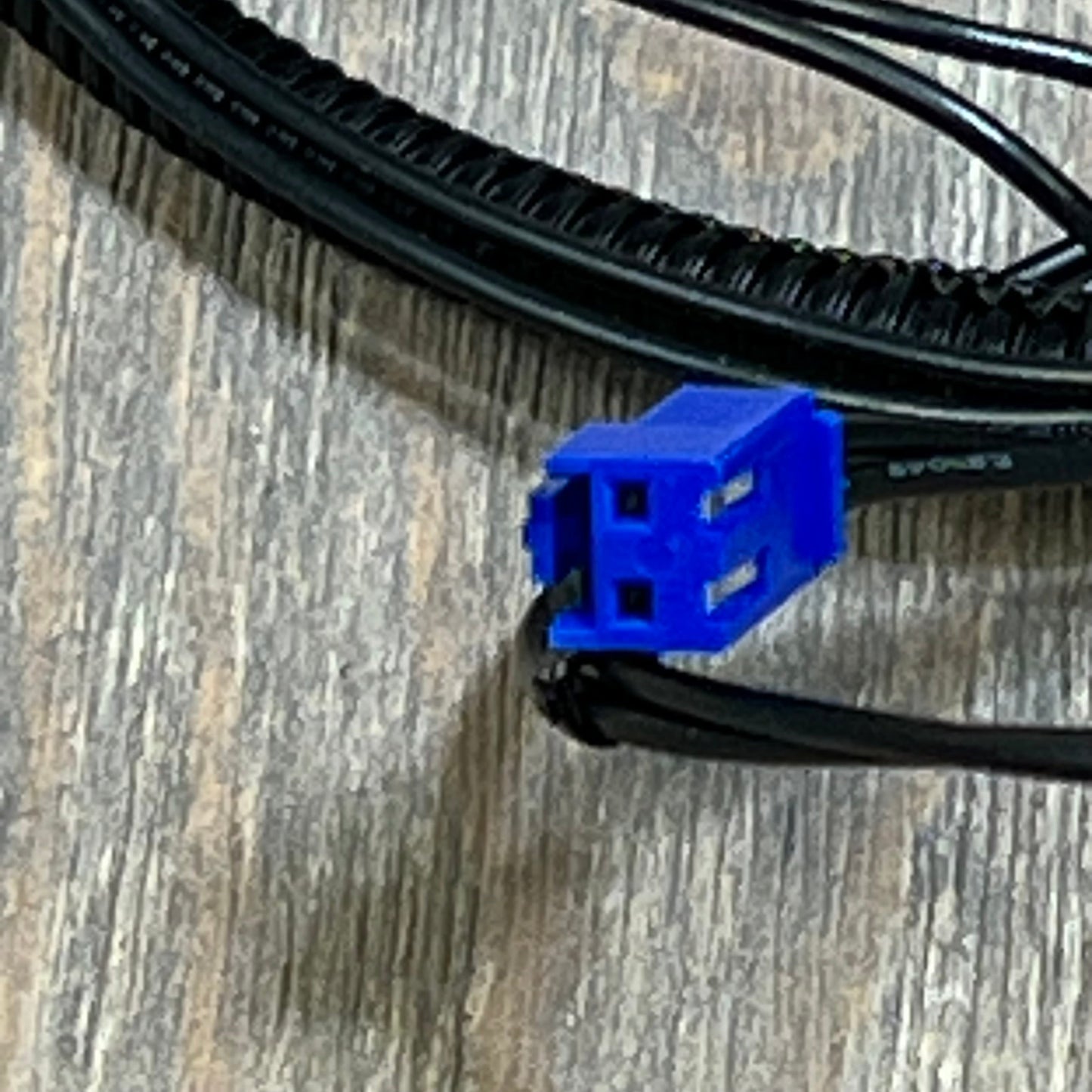 Blue connector of Hihitomorrow high limit switch wire harness for Zodiac Jandy pool heaters on wooden surface.