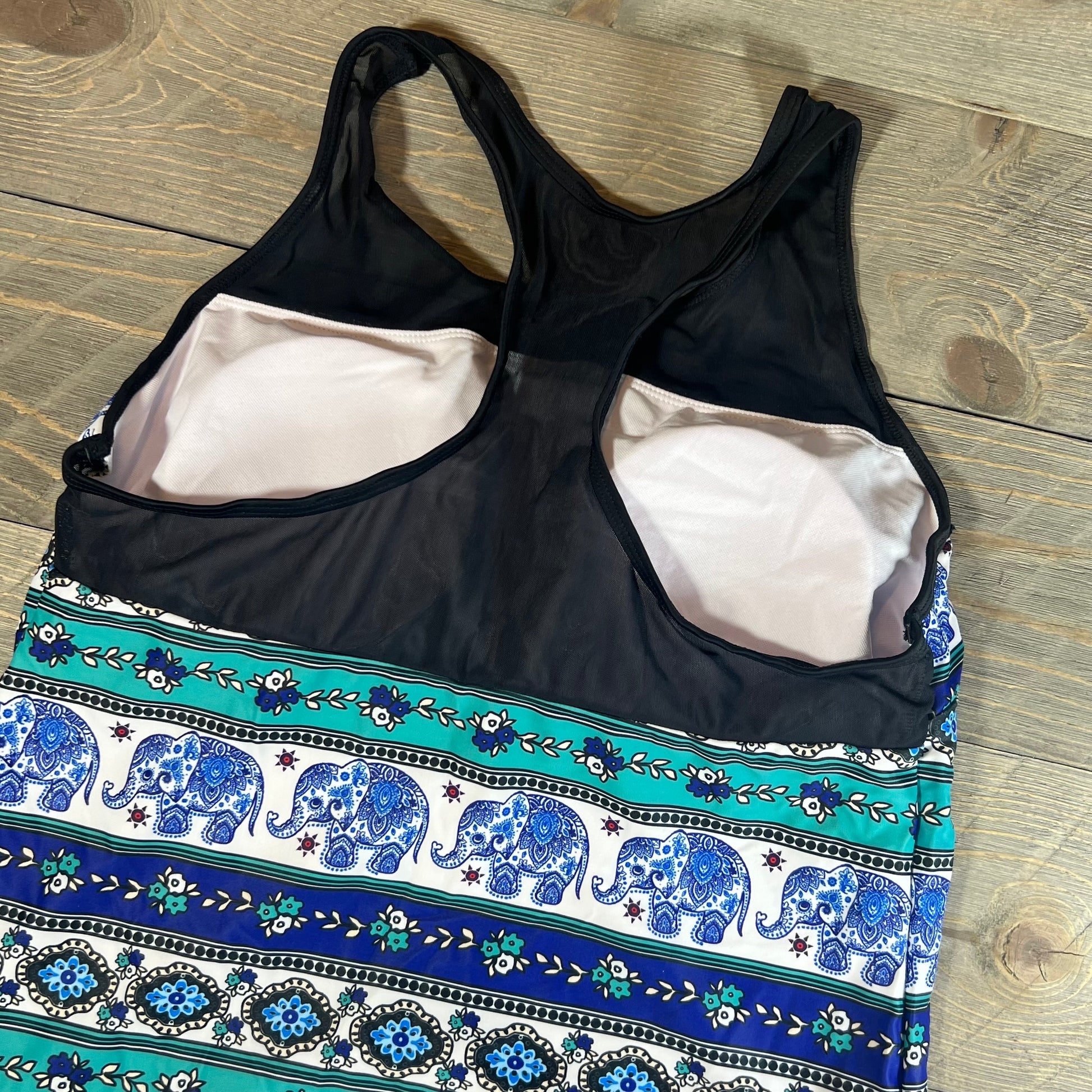 Blue mandala tankini swimsuit with elephant pattern, size L, featuring a racerback design on a wooden surface.
