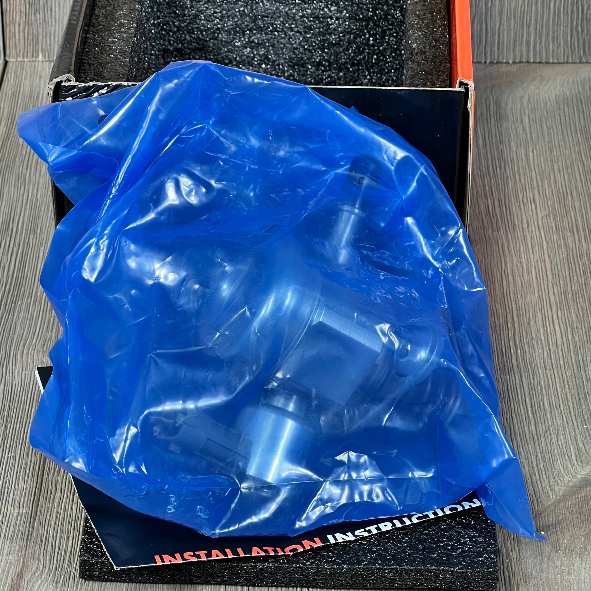 High pressure fuel pump for Ford and Lincoln models, packaged securely in blue wrap with installation instructions.