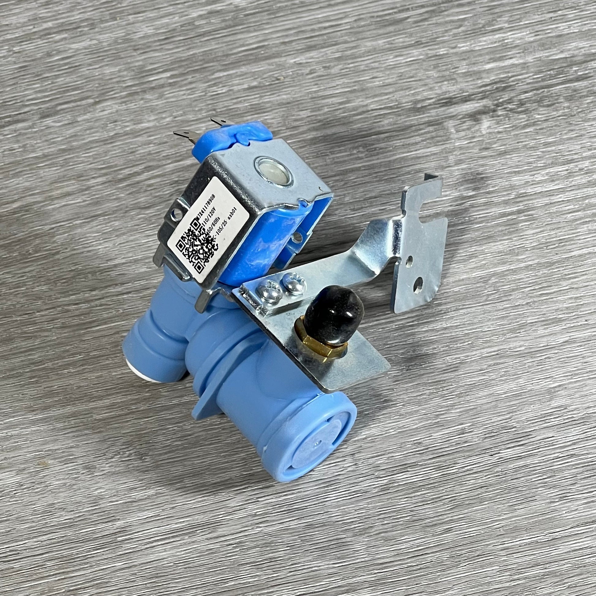 BlueStars MJX41178908 water inlet valve for LG & Kenmore refrigerators, shown on a wooden surface.