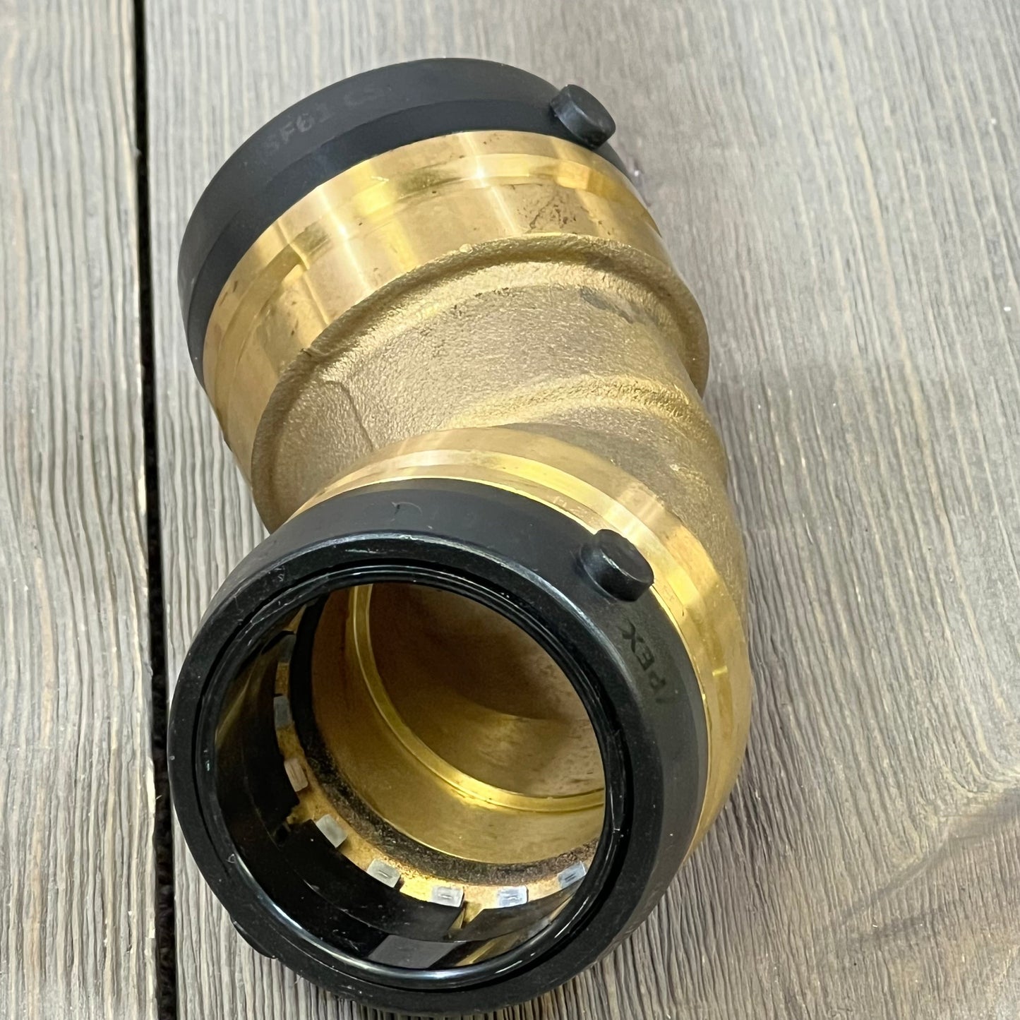 Push-to-connect SharkBite 1-1/2 inch 45-degree elbow plumbing fitting, compatible with PEX, copper, and CPVC pipes.