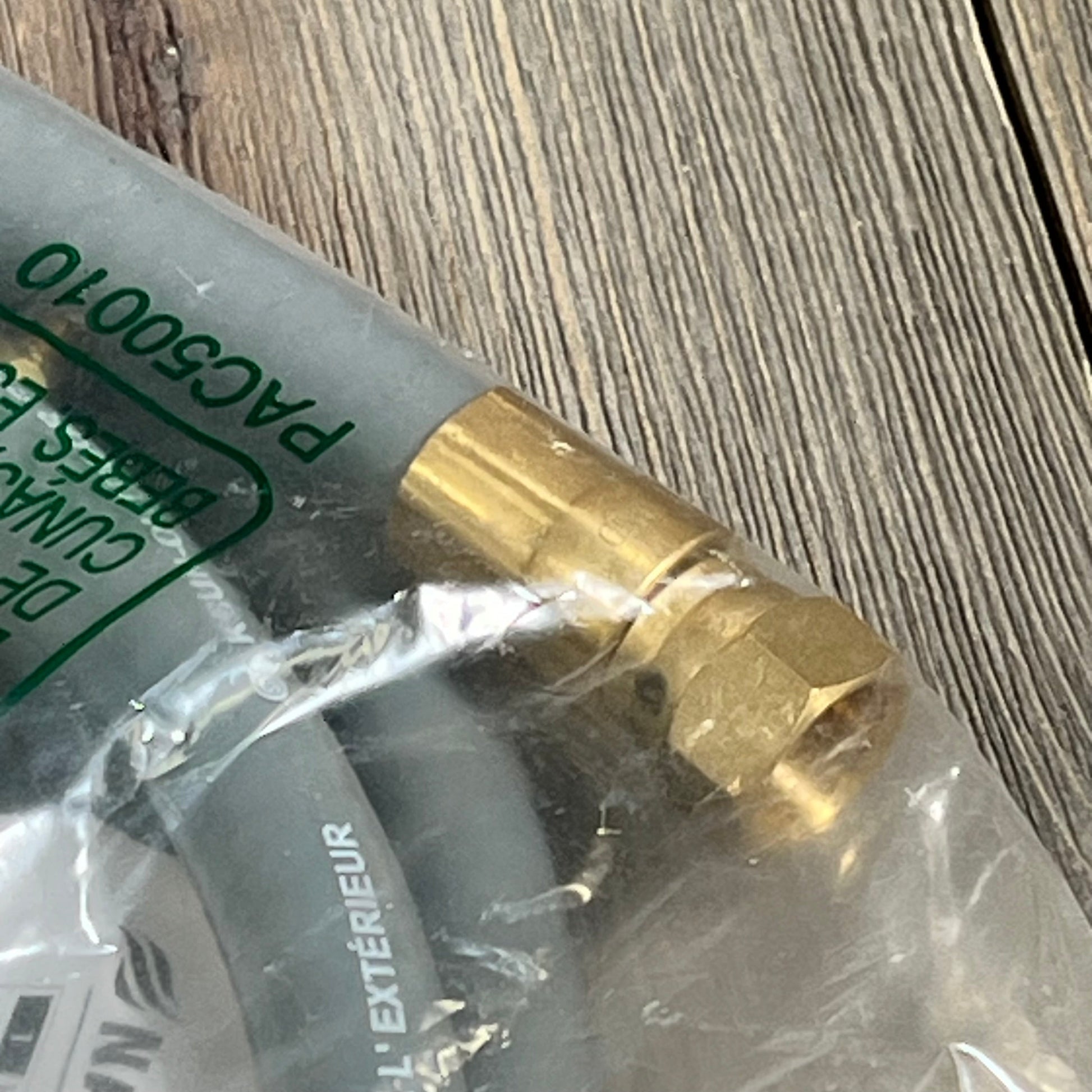 Gray hose with brass connector from Blackstone 5249 Propane to Natural Gas Conversion Kit, ideal for seamless gas conversion.