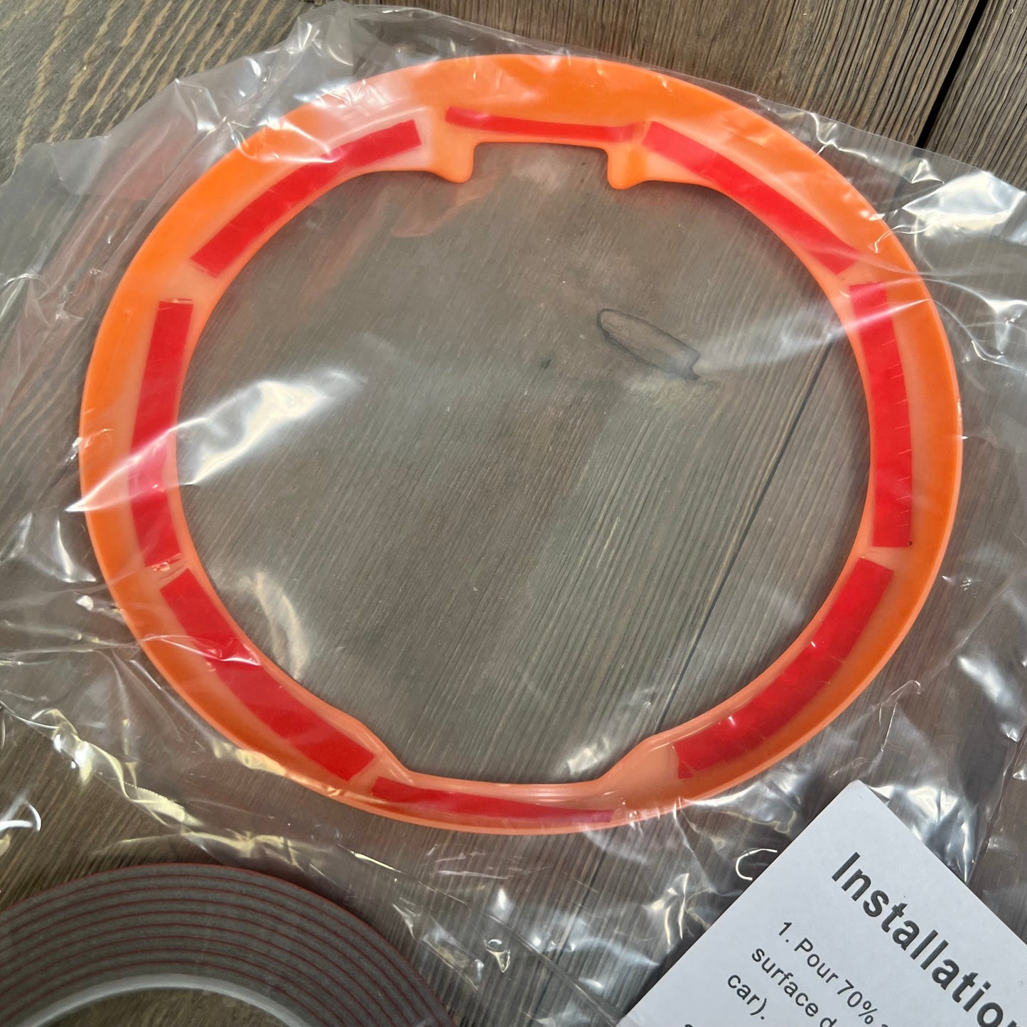 Orange fuel door trim for Jeep Wrangler JL JLU 4xe & Gladiator JT, packaged with installation instructions.