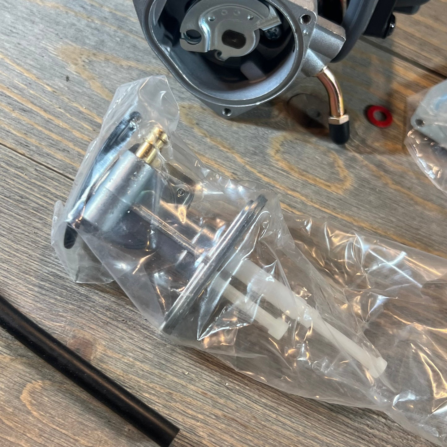Carburetor replacement for Suzuki LTZ400 Quad 2003-2007, showing detailed components and fuel valve petcock wrapped.