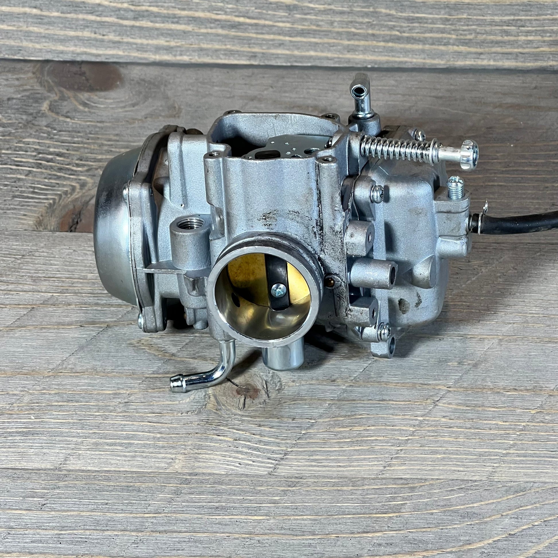 Carburetor replacement part for Polaris Sportsman 500, showcasing intricate design and metallic finish.