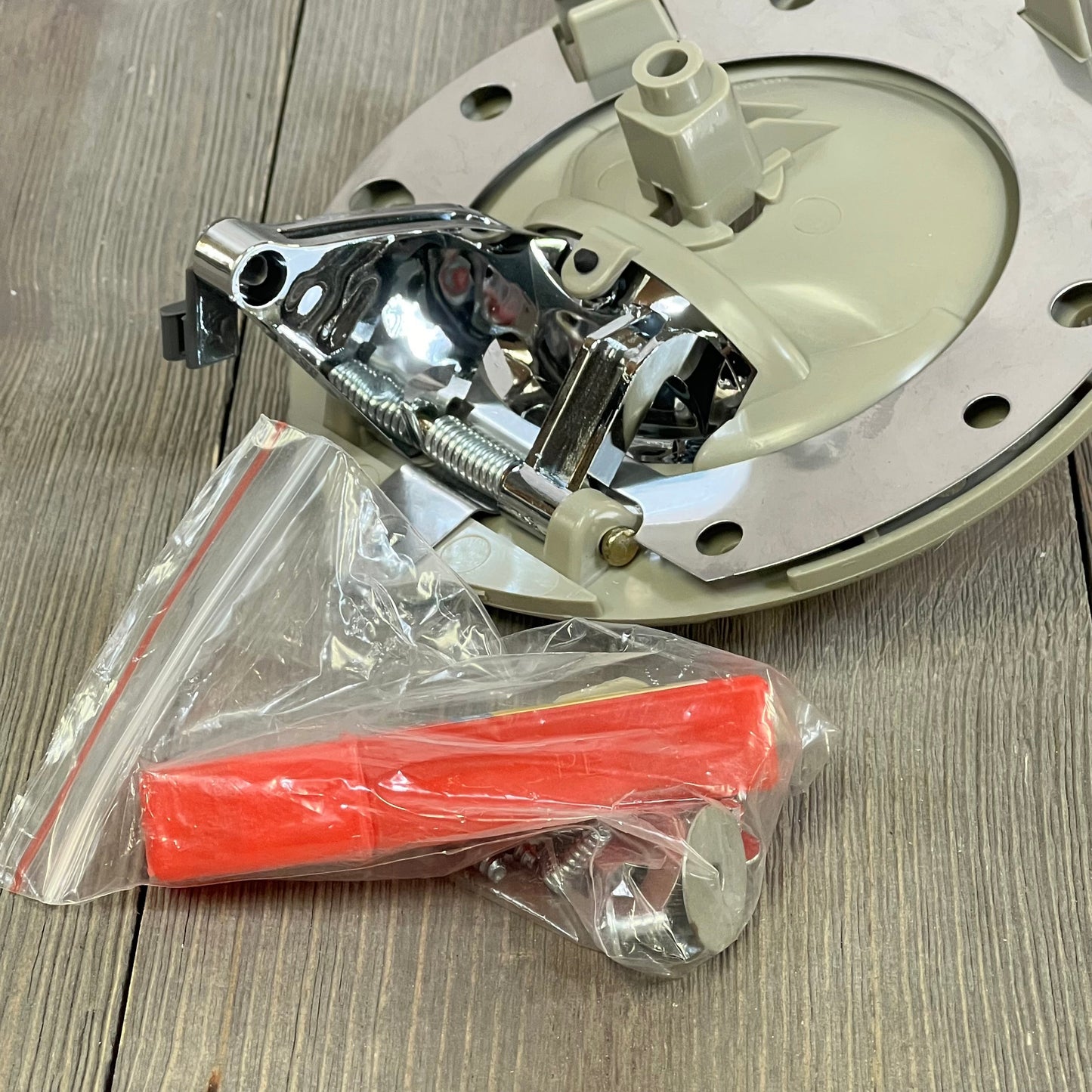 Tan chrome bolt inside door handle set for Jeep Commander 2006-2010, with installation accessories on wooden surface.