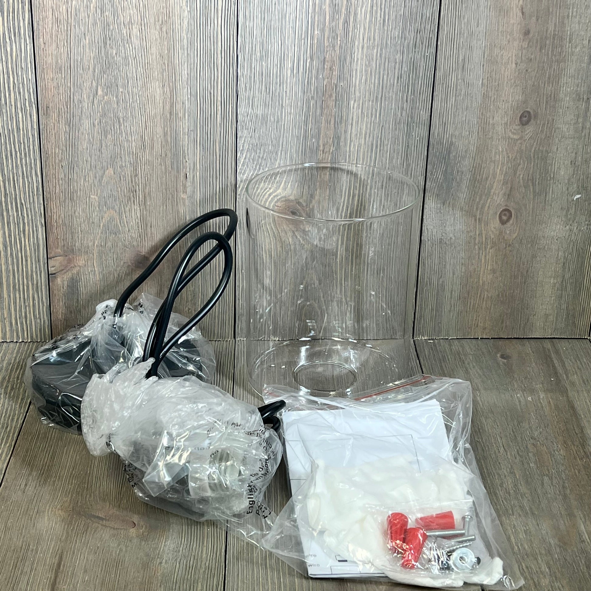 Modern farmhouse pendant light with glass shade, adjustable hanging fixtures, black finish, industrial style components.