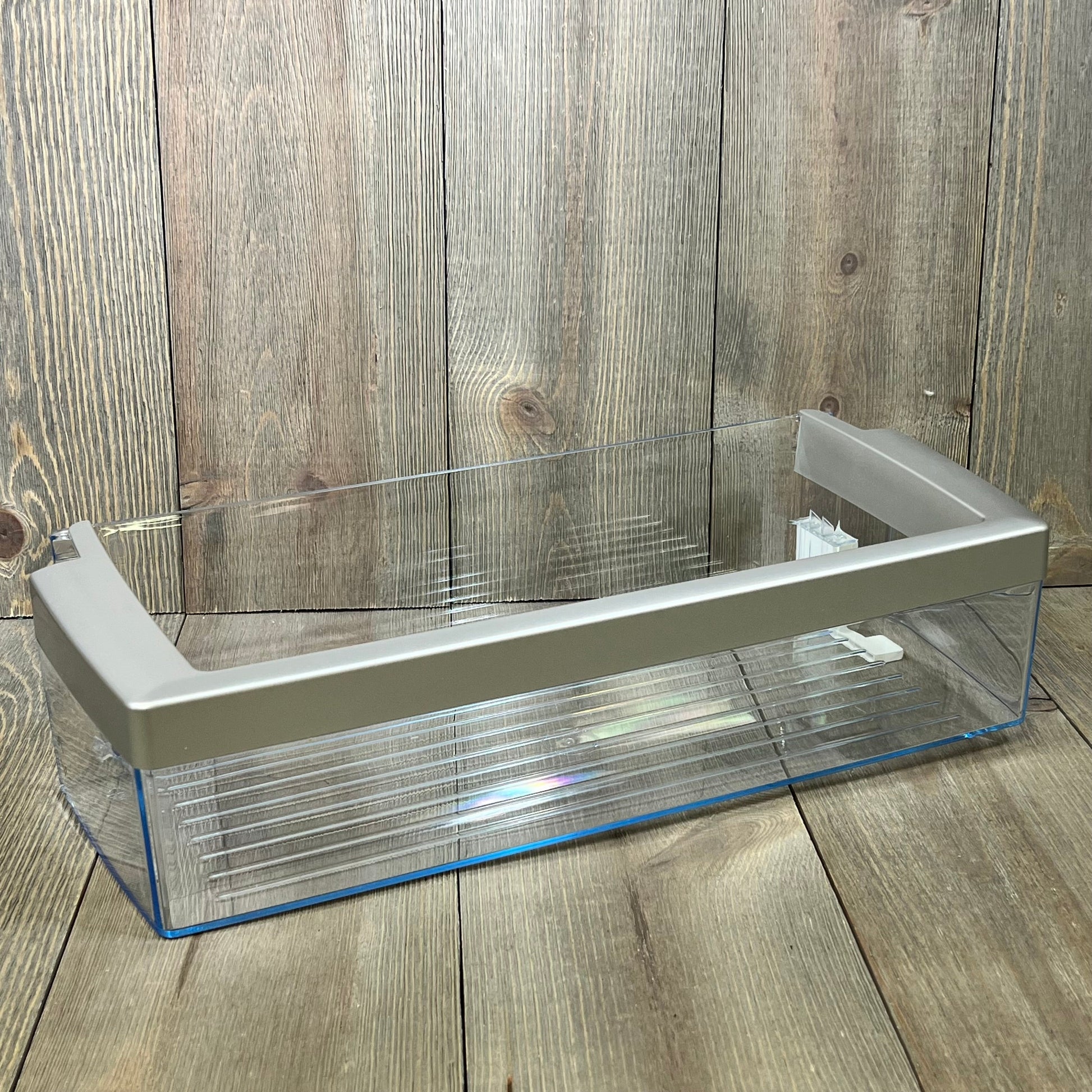 Transparent refrigerator door shelf bin compatible with Bosch 00673122, featuring durable plastic and sleek design.
