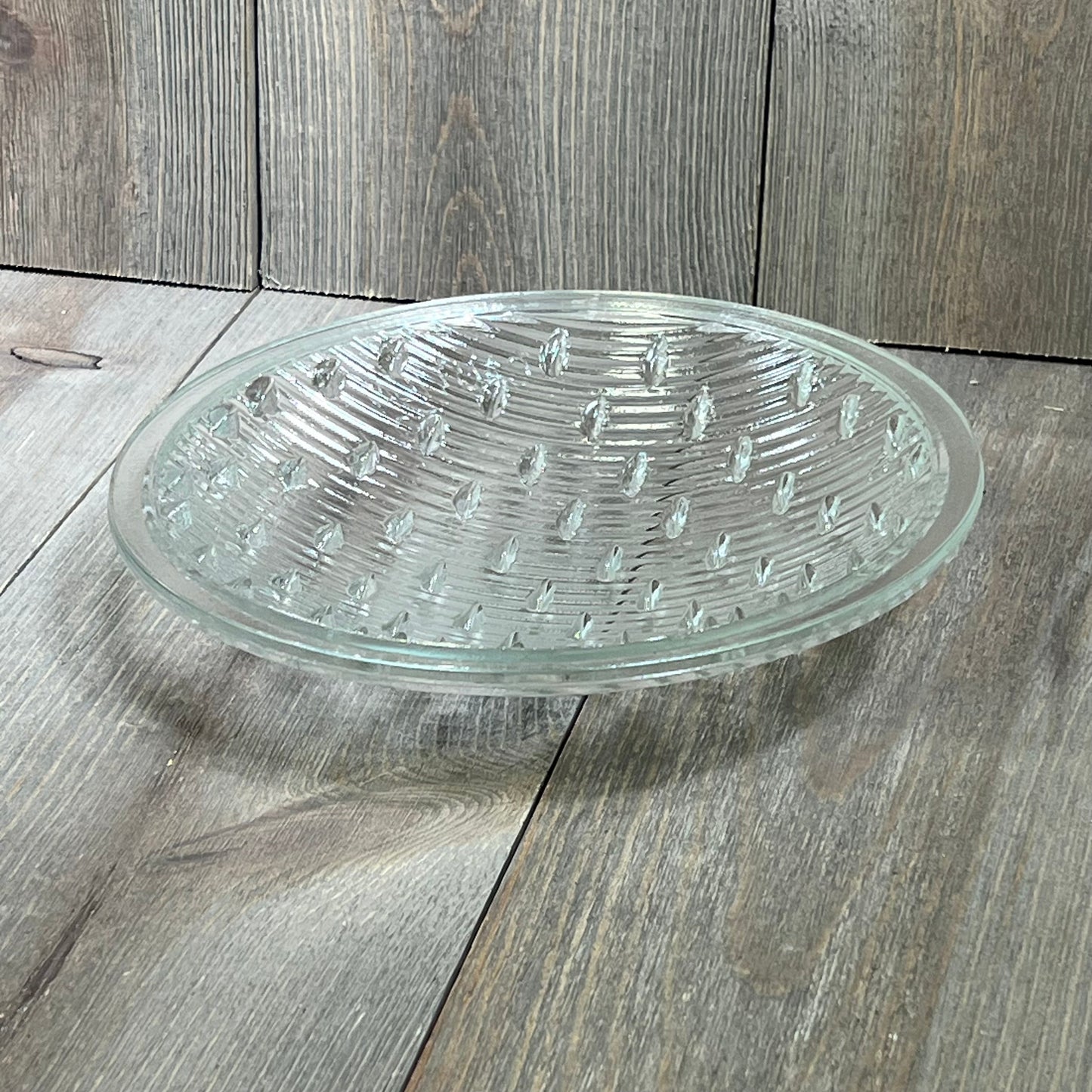Tempered clear lens for Hayward underwater lights, 7-9/16 inches in diameter, resting on a wooden surface.