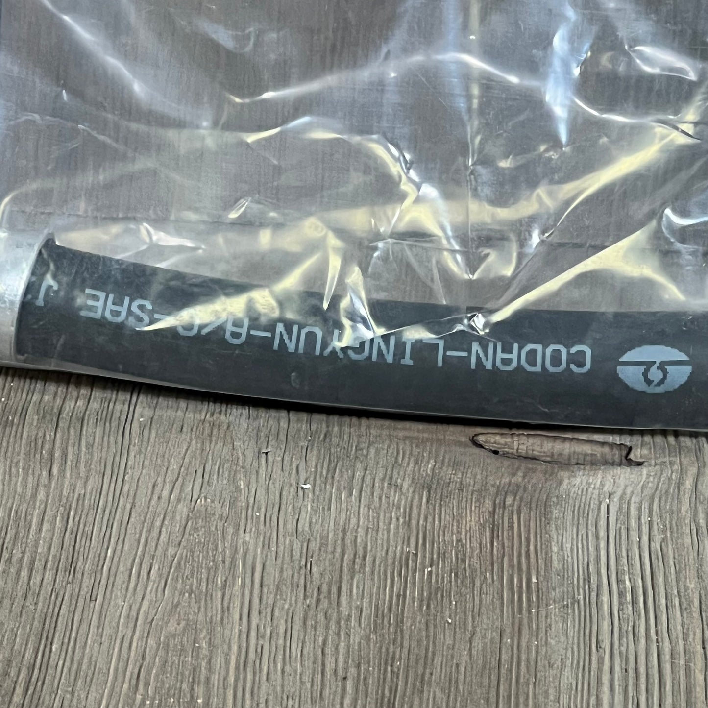 Premium A/C discharge line hose assembly for Jeep Wrangler 2007-2011, shown in protective packaging.