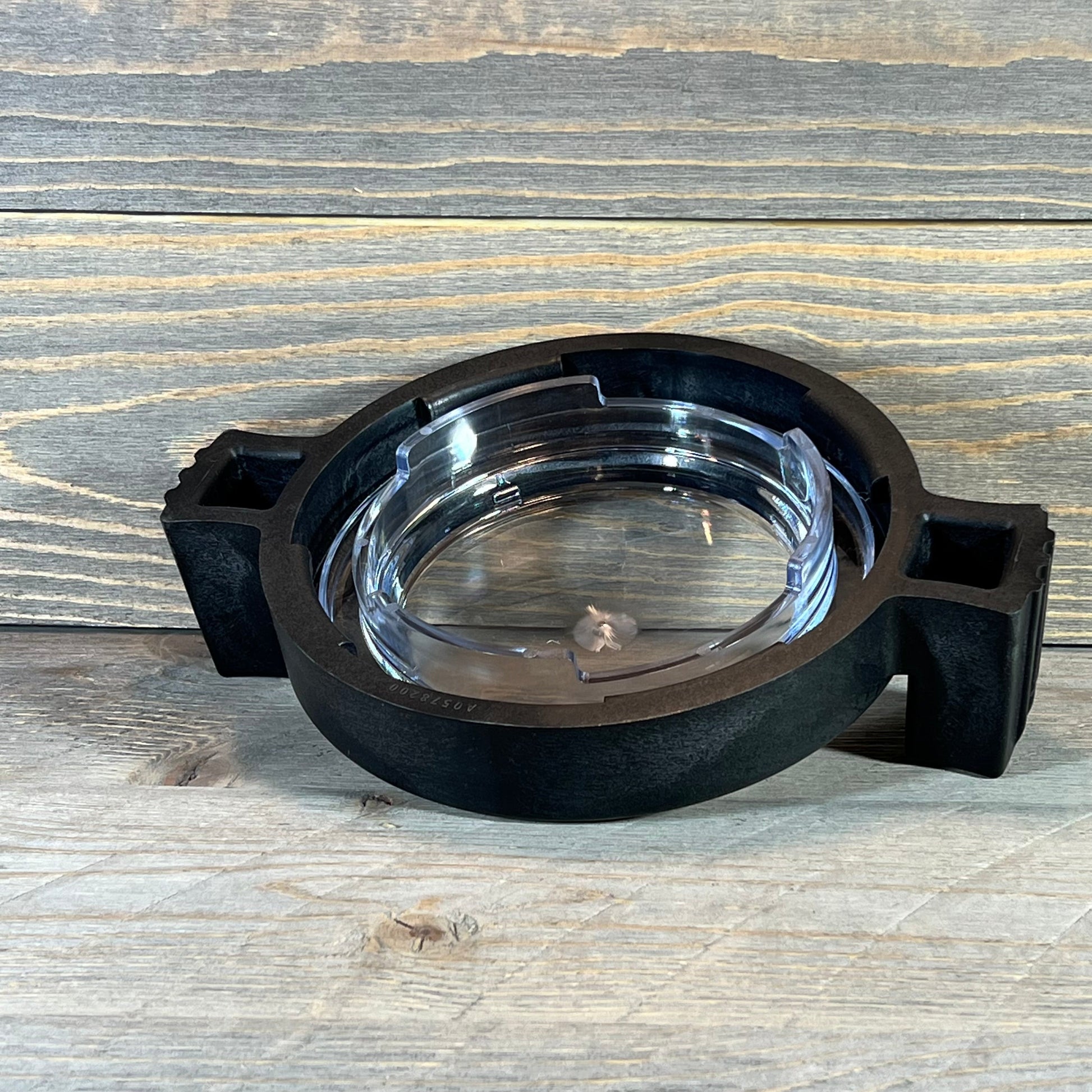 Clear pool pump lid with locking ring and O-ring, compatible with Zodiac Jandy PlusHP models, on wooden surface.