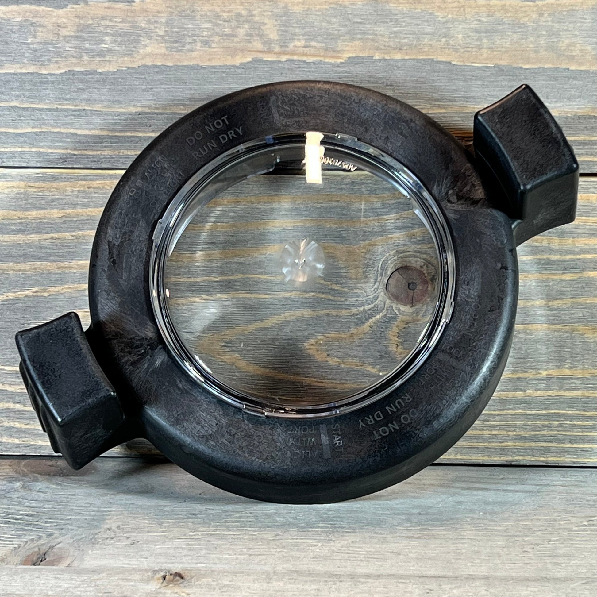 Clear pool pump lid with locking ring and O-ring for Zodiac Jandy PlusHP models on wooden background.