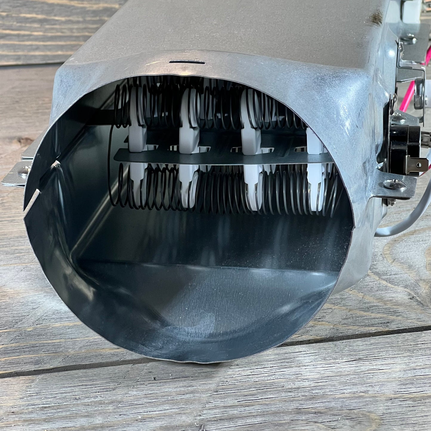 Close-up of 1048541548-5301EL1001H dryer heating element showing coil design for LG and Kenmore dryers.