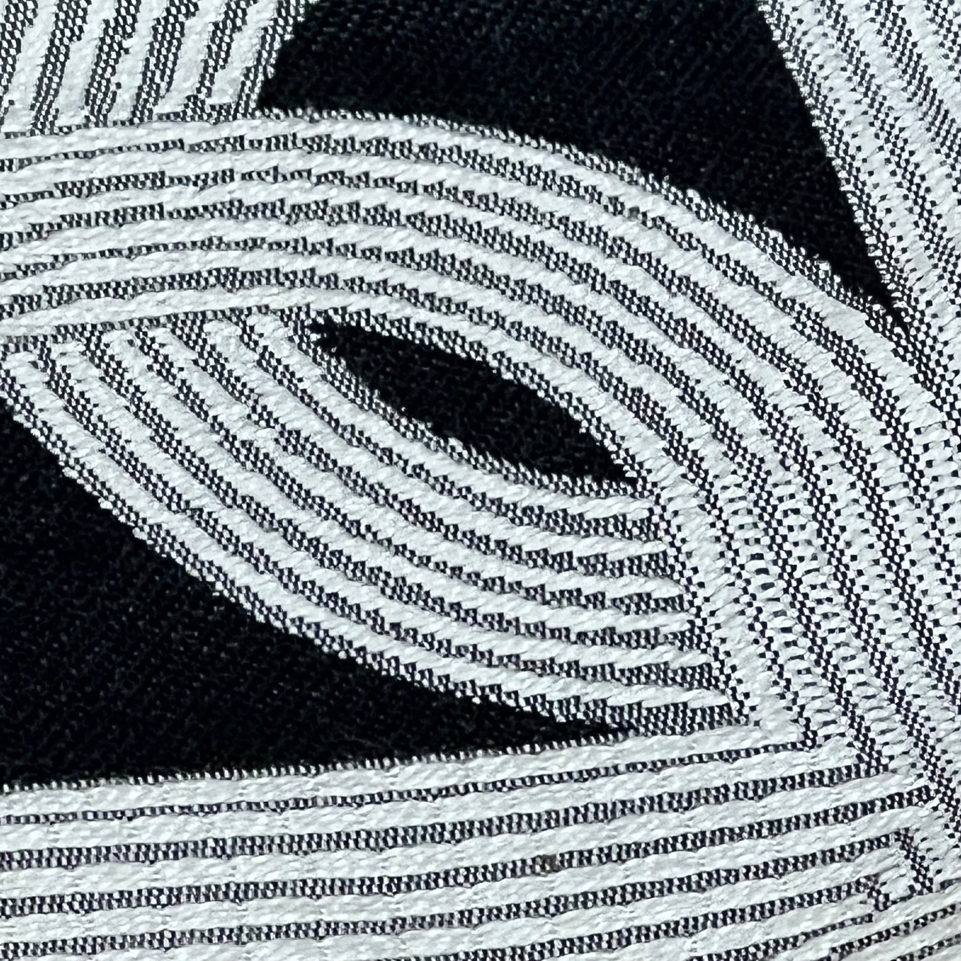 Black embroidery detail on Croker Horse 18x18'' pillow cover, showcasing pig nose horseshoe design for modern luxury decor.