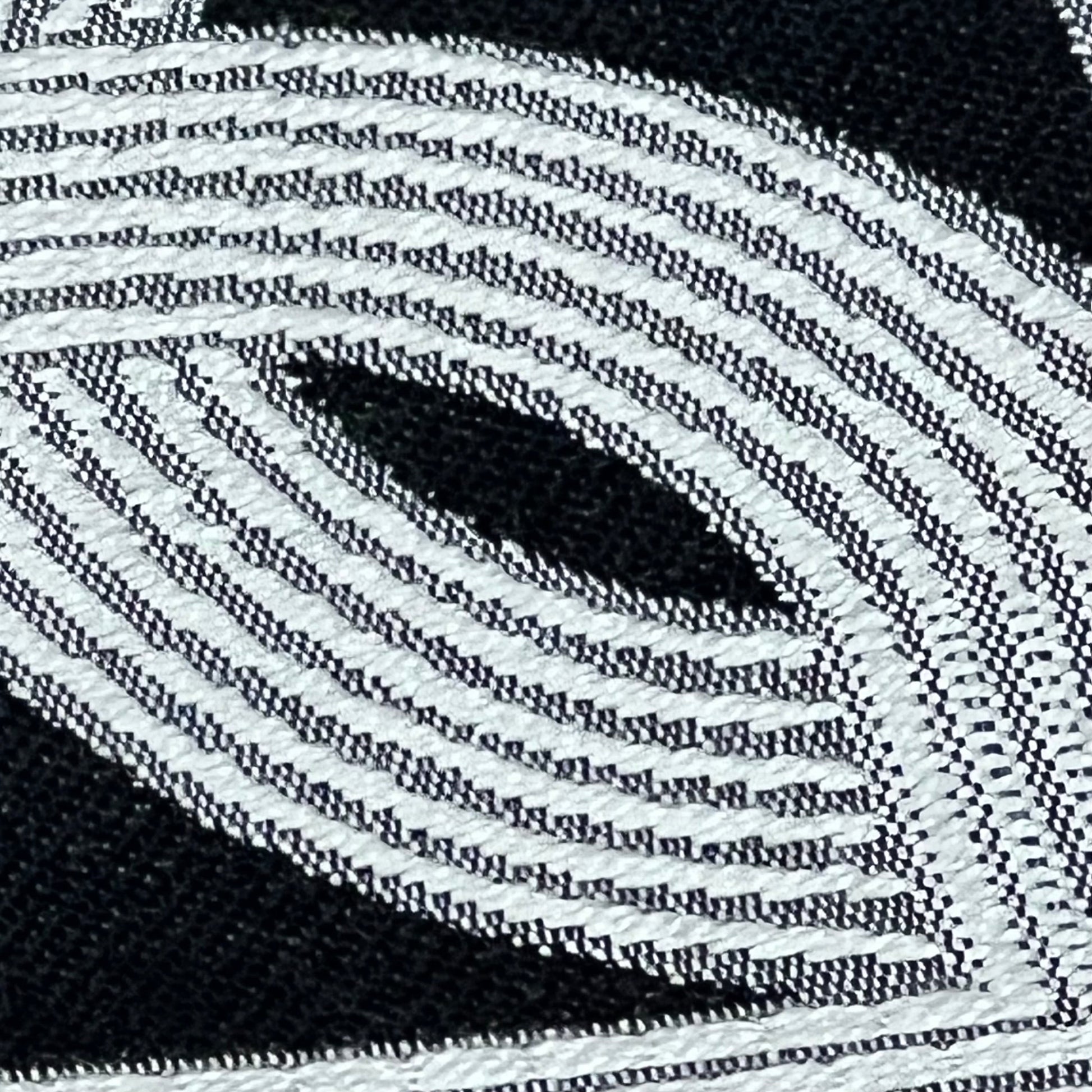 Close-up of black embroidery on Croker Horse 18x18 throw pillow cover, showcasing intricate pig nose horseshoe design.