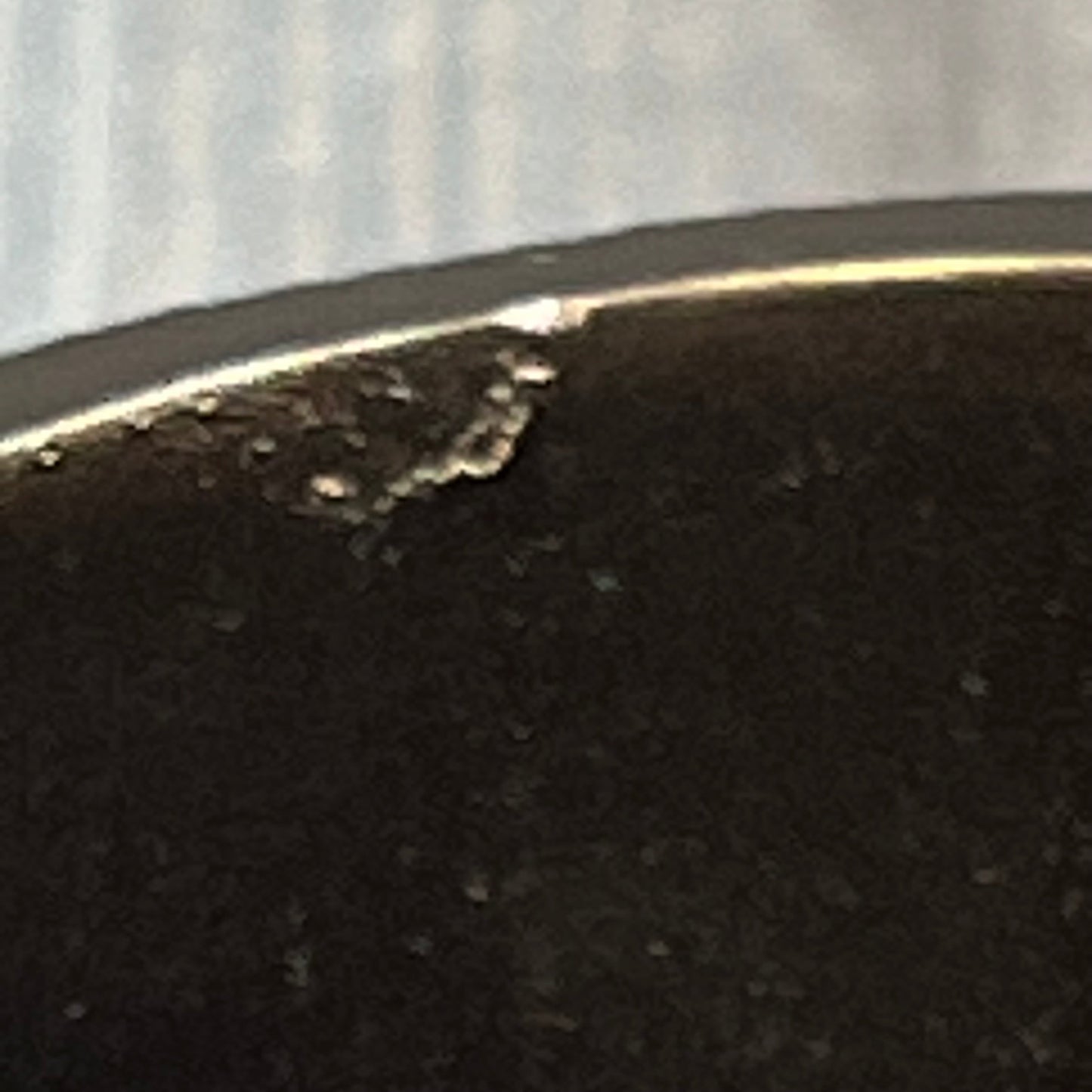 Close-up of a burgundy tumbler edge with slight imperfections, part of the Popular Bath Ombre Rose Design collection.
