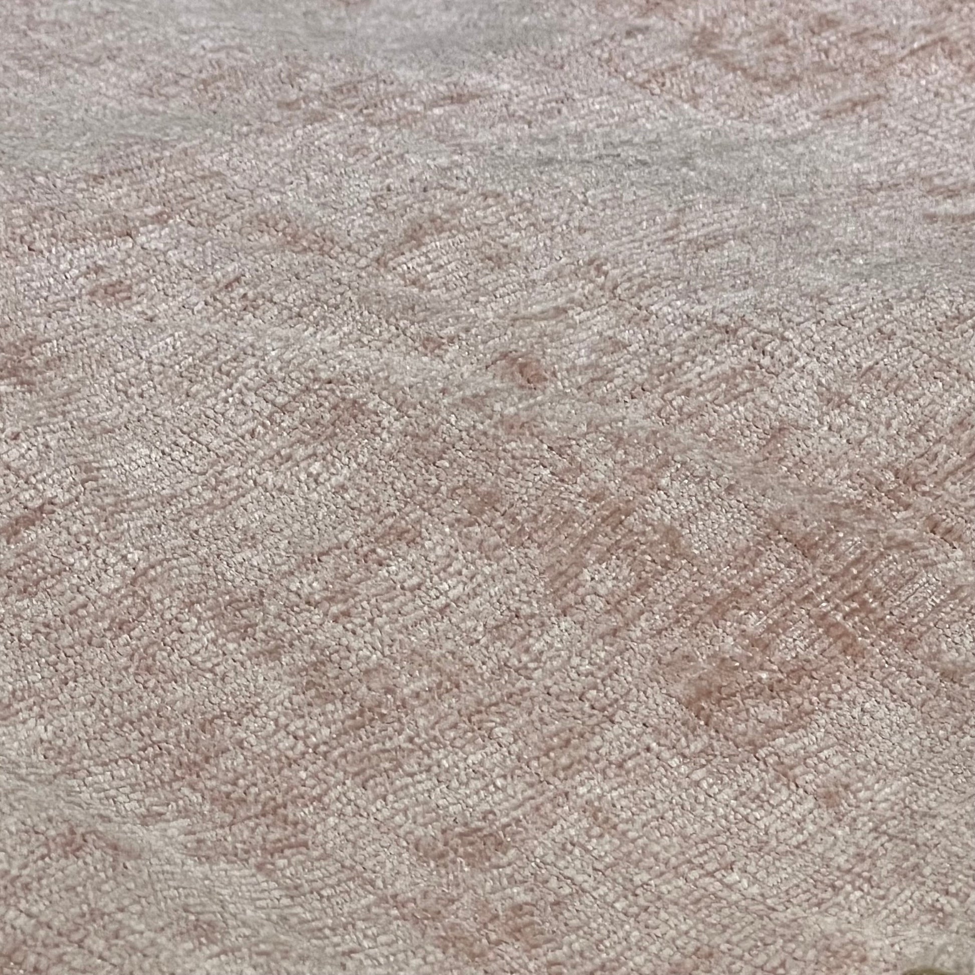 Close-up of ANRODUO blush pink chenille fabric showcasing texture and stitched edge for farmhouse pillow covers.