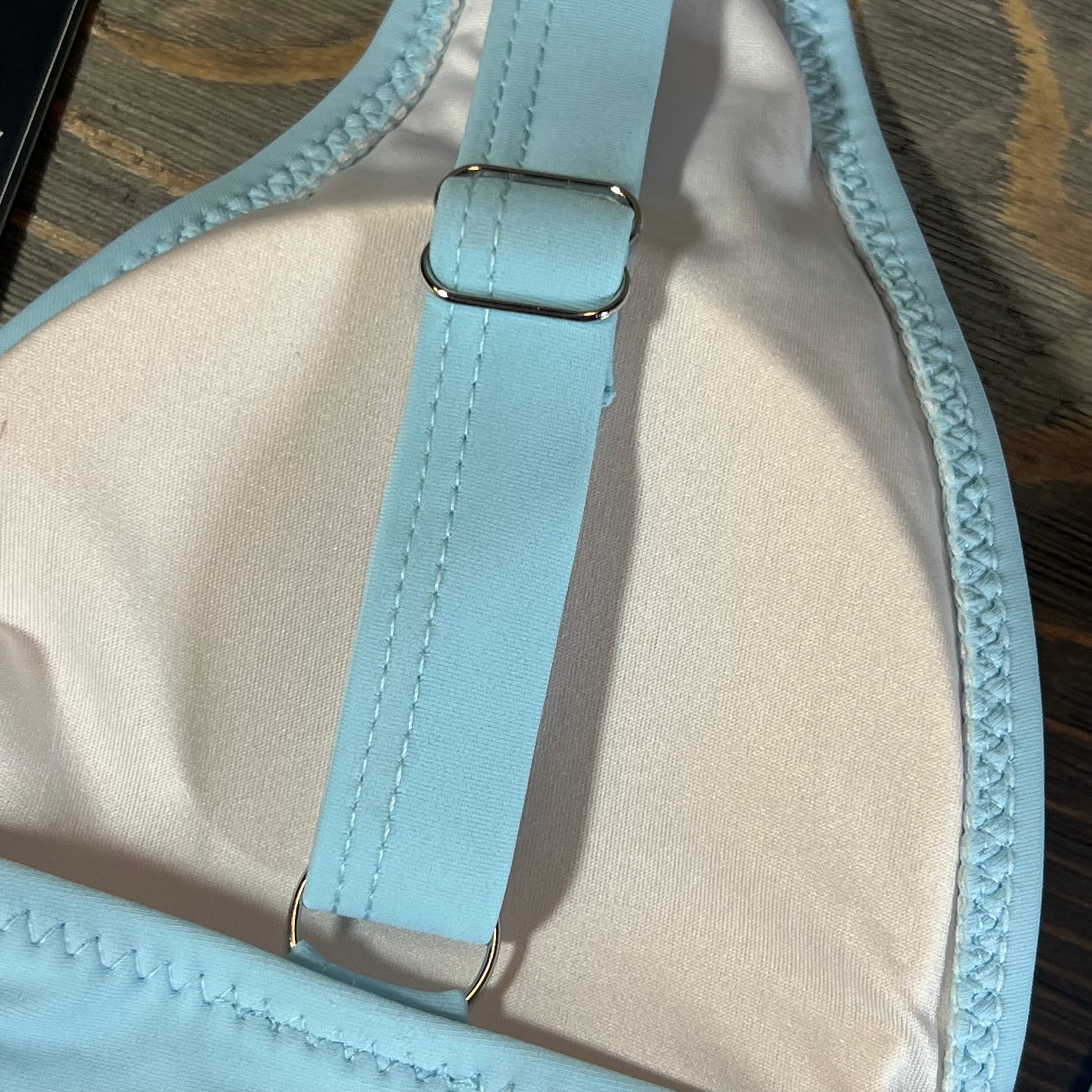 Close-up of adjustable strap on Blooming Jelly women's blue bikini top, highlighting quality stitching.