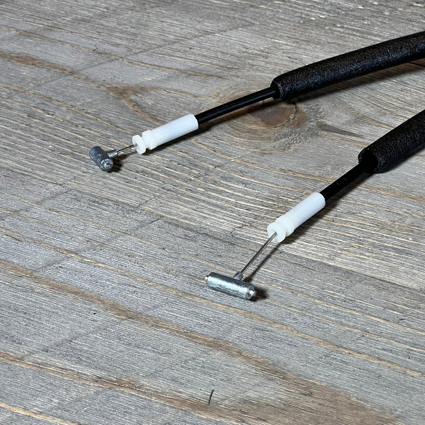 Close-up of Hyundai Santa Fe door lock actuator components on wooden surface, highlighting cable and connectors.