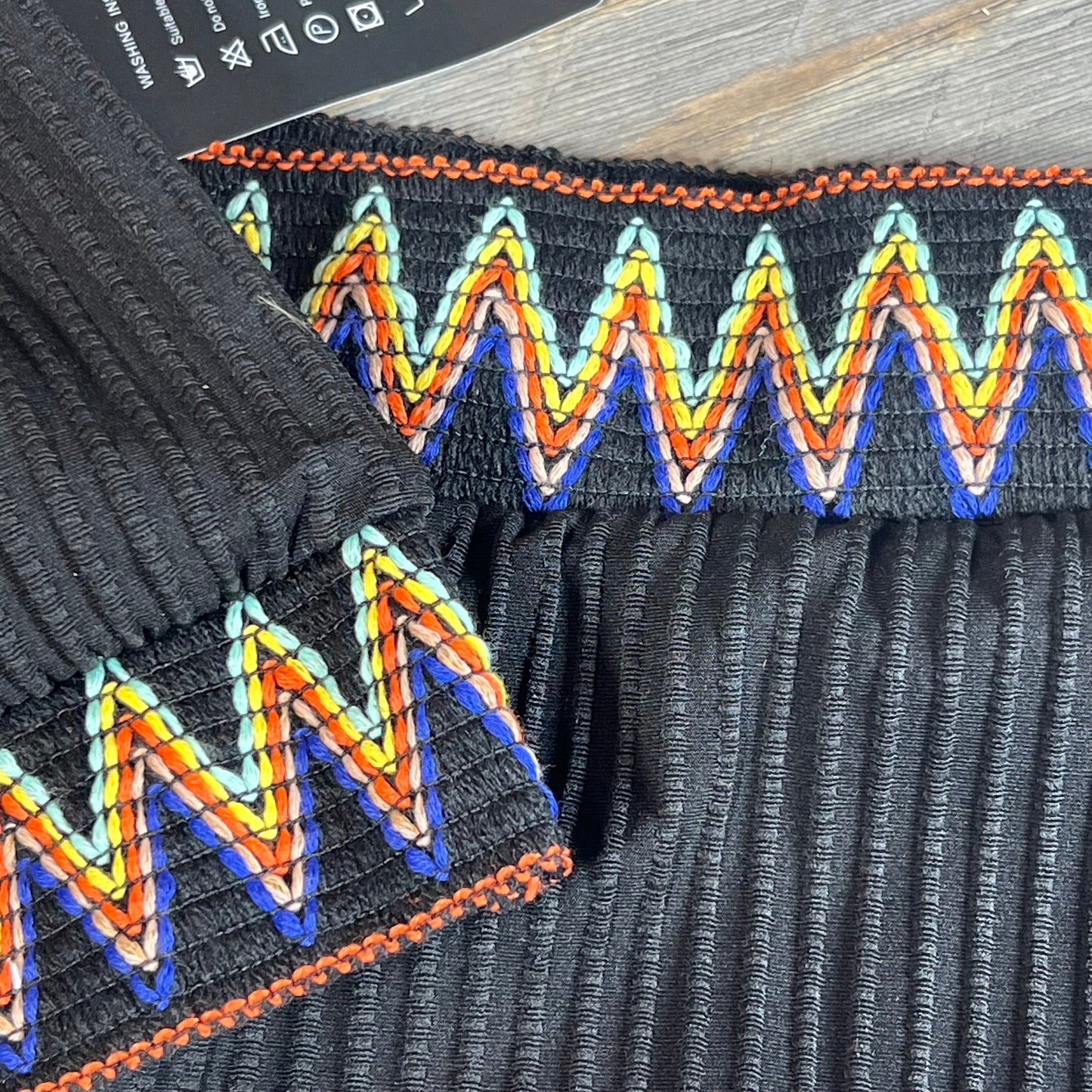 Close-up of Lilosy ribbed bikini set waistband with colorful zigzag stitching, showcasing texture and detailed design.