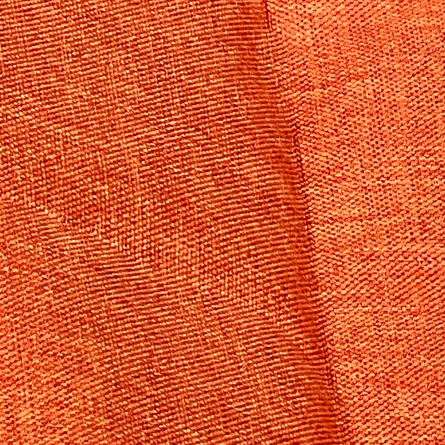 Close-up of orange fabric texture on Woaboy waterproof throw pillow covers, perfect for outdoor patio or sofa decor.