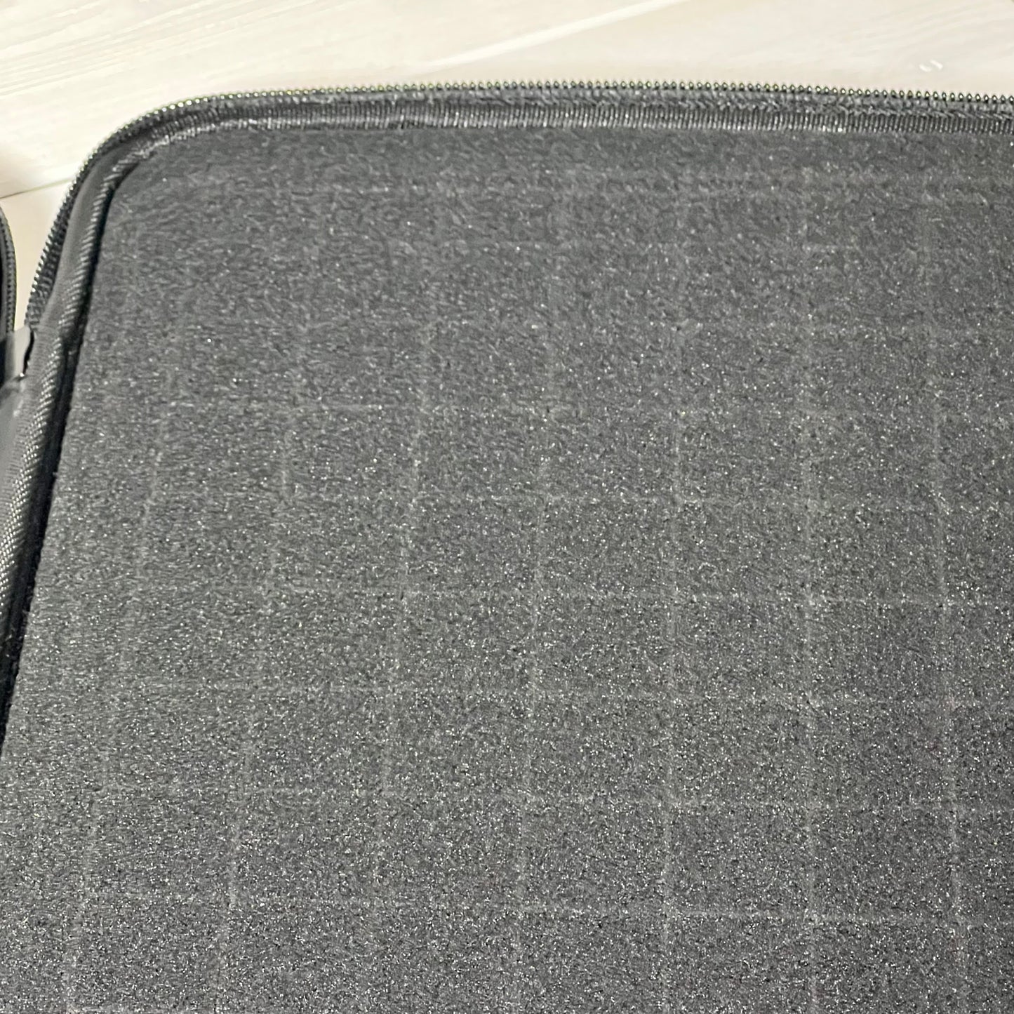 Close-up of pre-cut customizable space sponge in Brappo Miniature Storage Case for secure figure storage.
