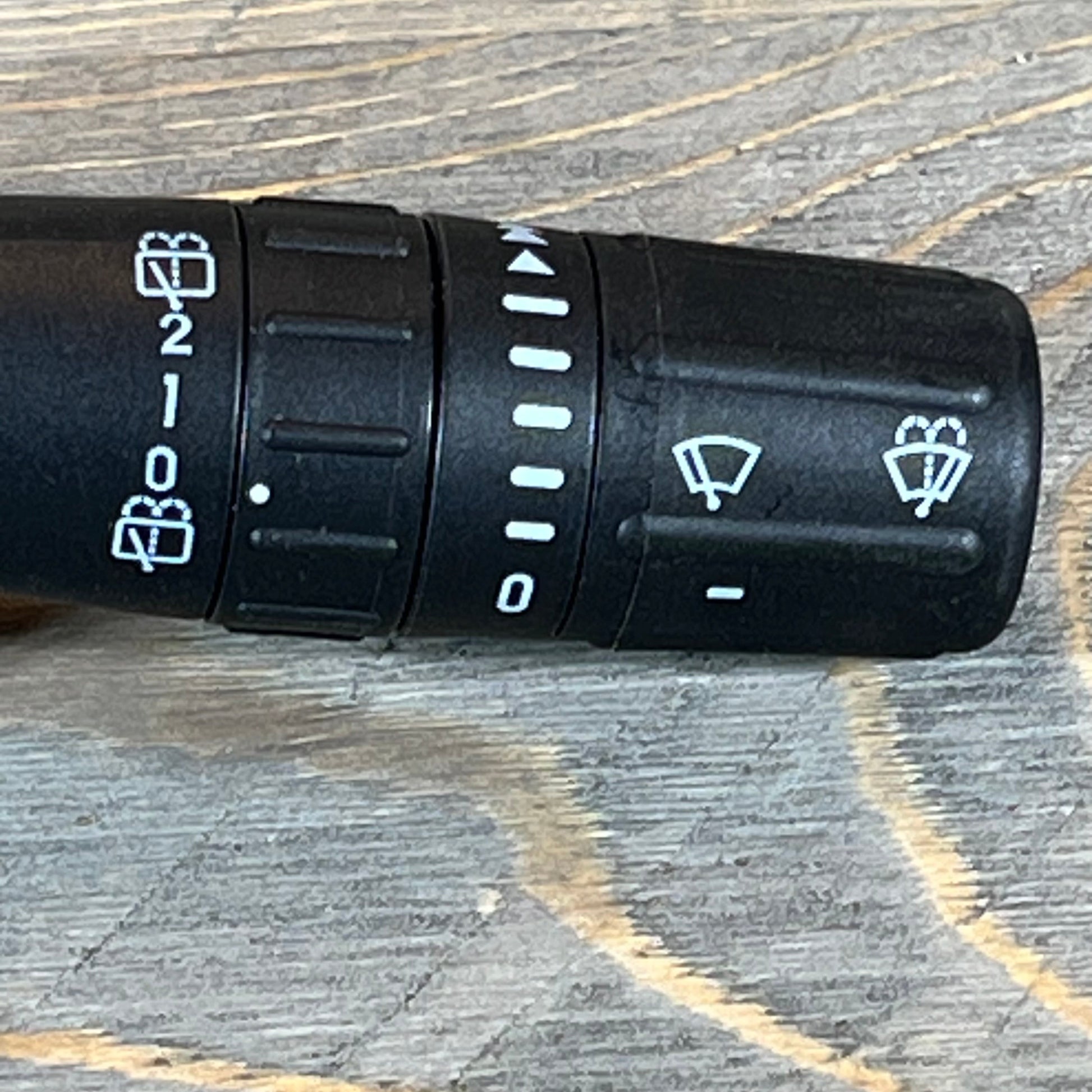 Close-up of the Ford Explorer windshield wiper switch, showing detailed control icons.