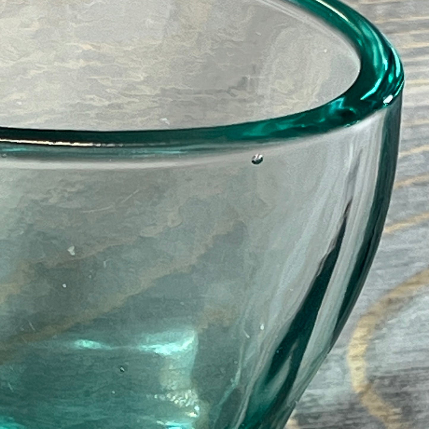 Close-up of the textured surface on a glass from the Green Teal Glass Bathroom Accessory Set.