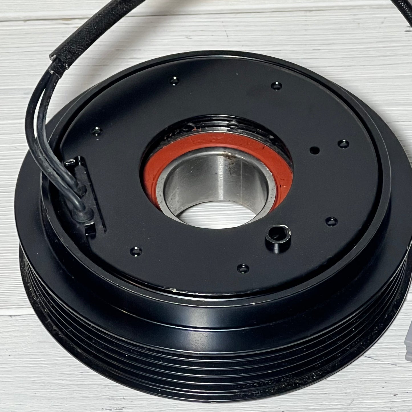 Close-up of the uxcell AC Compressor Clutch Set for Mazda 3, showcasing detailed design compatible with 2010-2013 models.