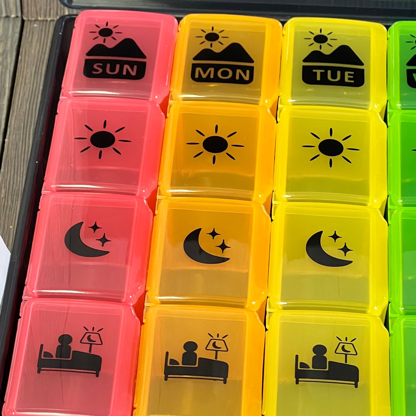 Colorful extra large weekly pill organizer with four daily compartments, perfect for vitamins and supplements.