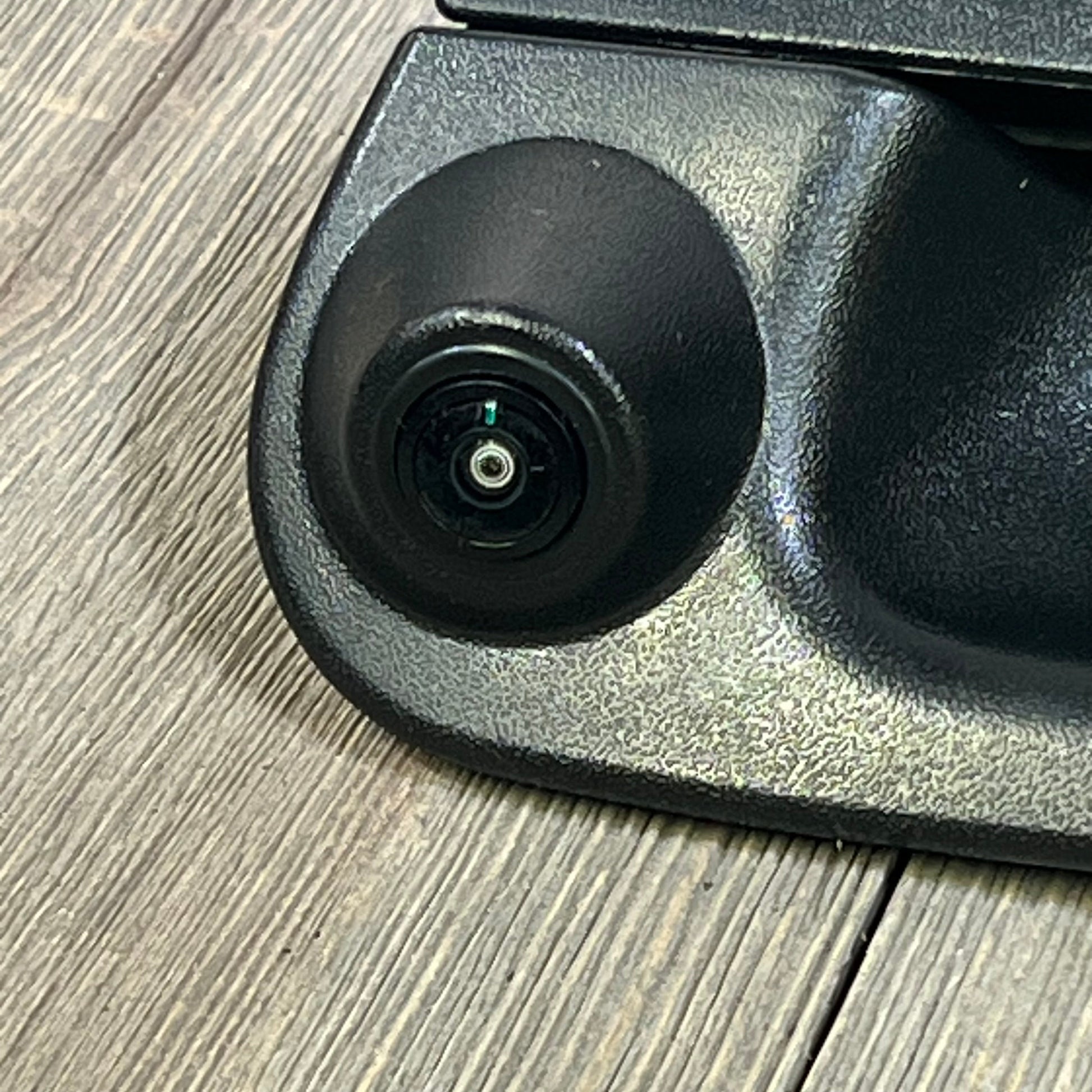Close-up of backup camera tailgate handle for Ford F-150 and F-250, showing lens detail and textured black finish.