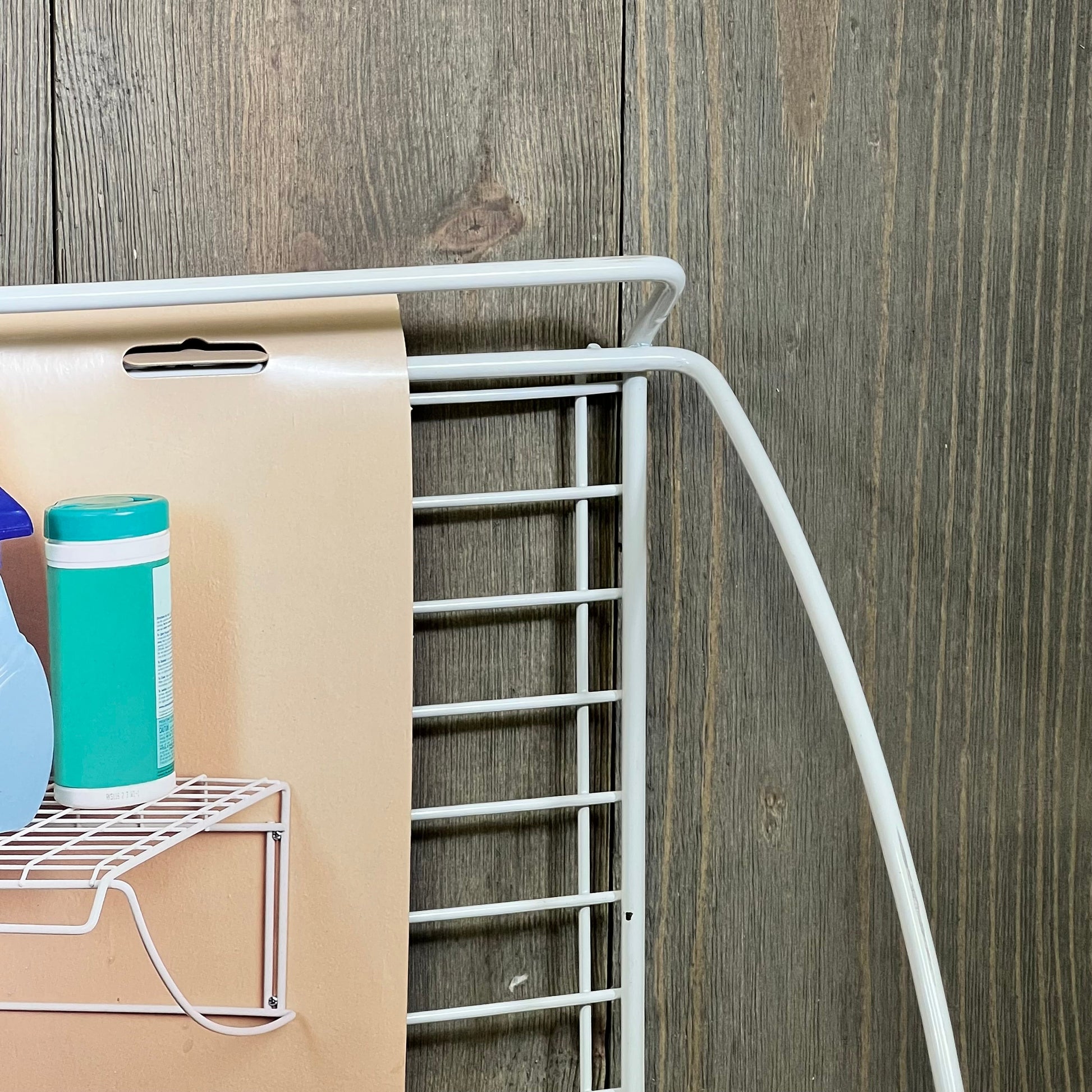 White ClosetMaid 8279 laundry utility hanger shelf, 24-inch wide, ideal for organizing laundry essentials, against wood backdrop.