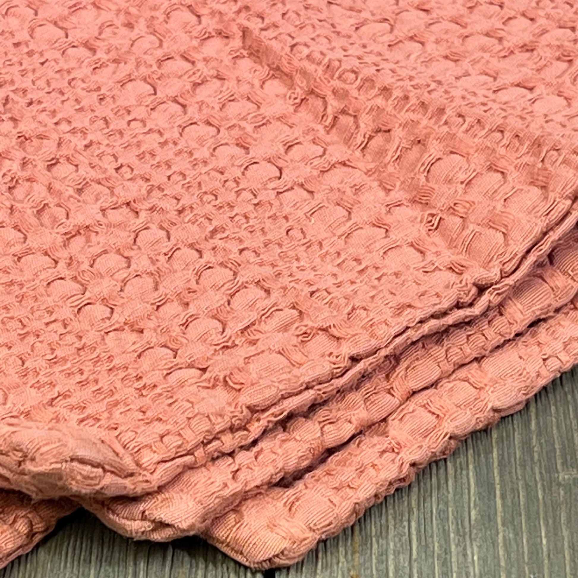 Coral pink boho pillow cover with textured cotton design, perfect for enhancing home decor on couch or bed.