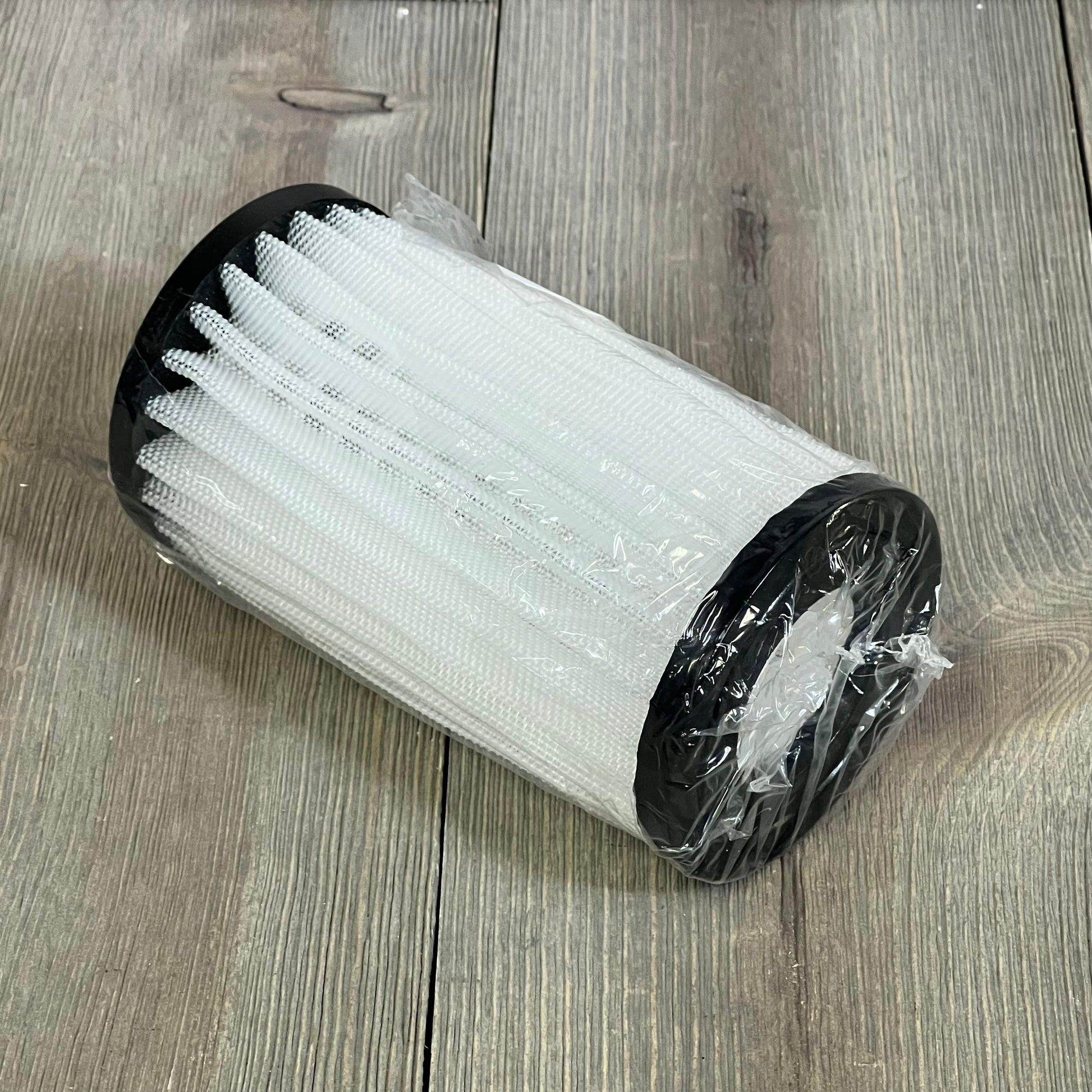 Energy filter element for Zodiac Jandy pool cleaner, wrapped in plastic, shown on a wooden surface.