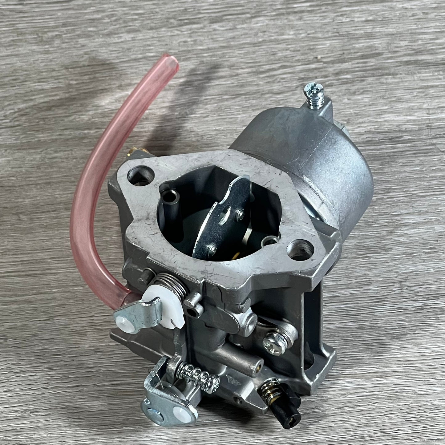 Cylinman Carburetor for John Deere mowers, showcasing durable construction and precise components on a wooden surface.