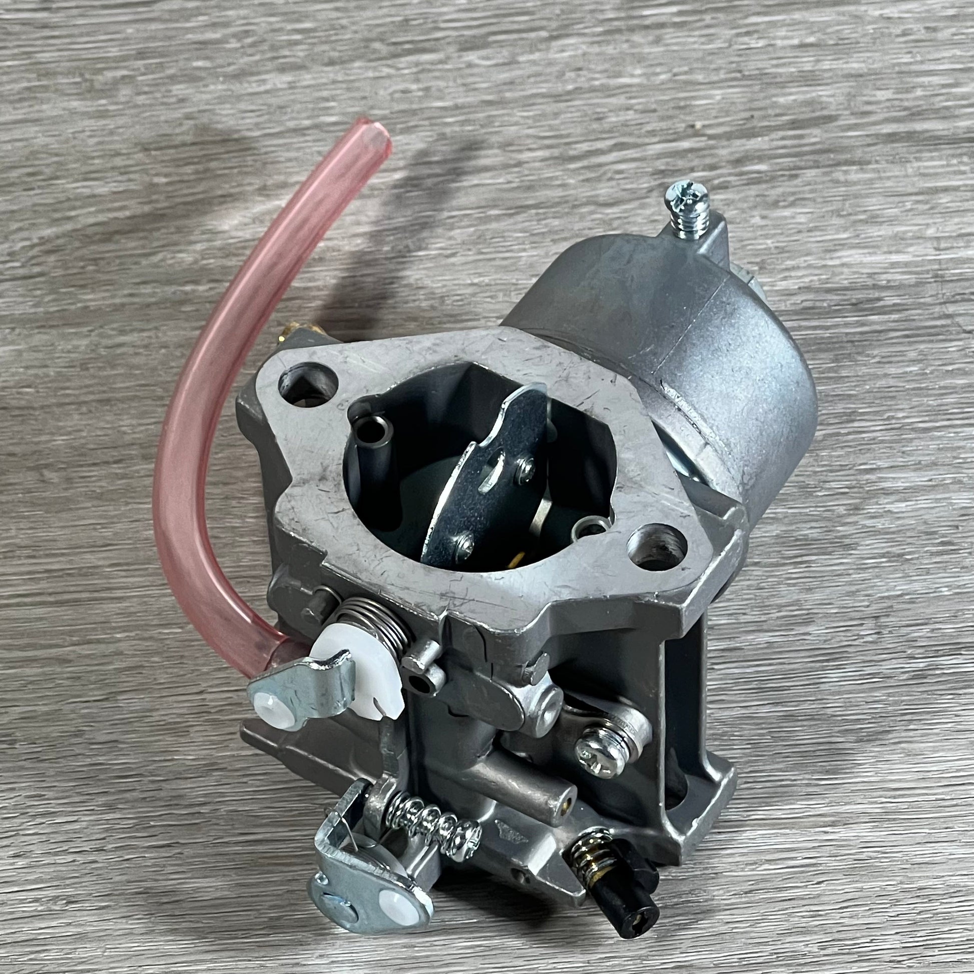Cylinman Carburetor for John Deere mowers, showcasing durable construction and precise components on a wooden surface.