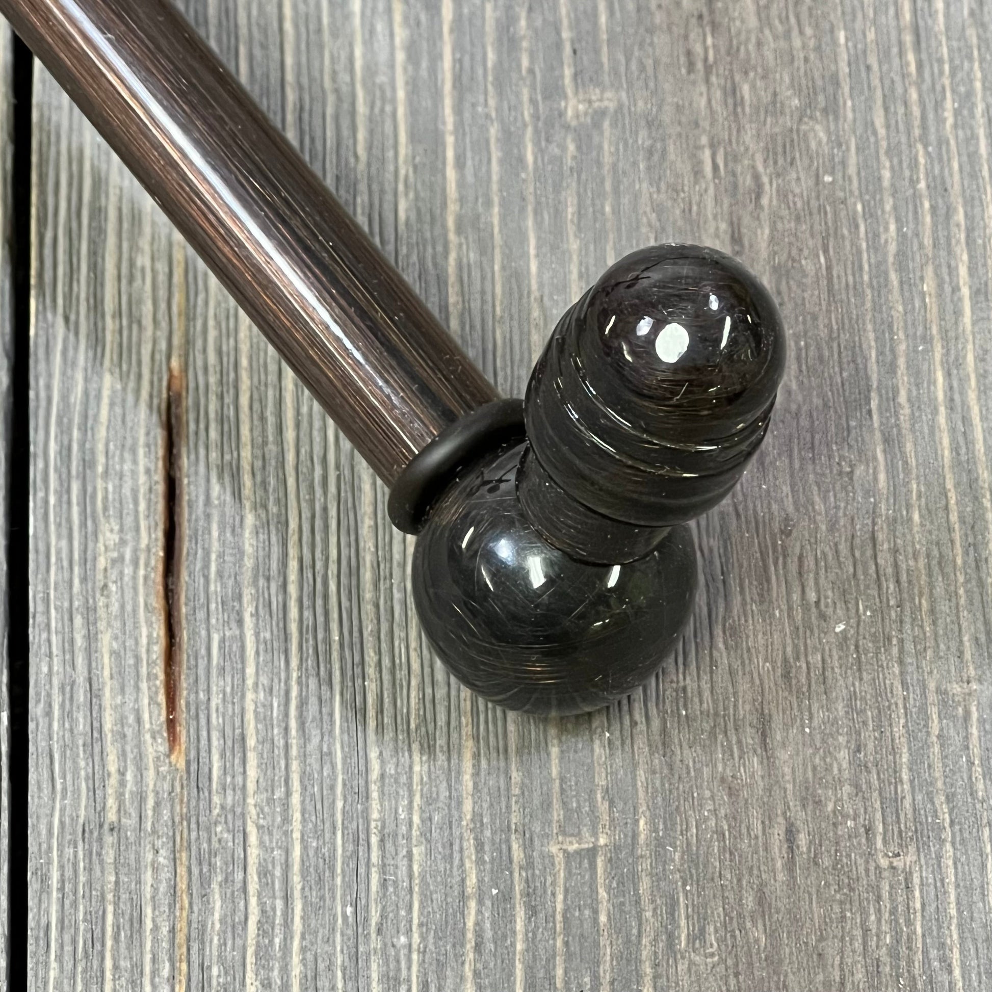 Antique copper swing arm towel rail from Allied Brass Waverly Place Collection on a rustic wooden surface.