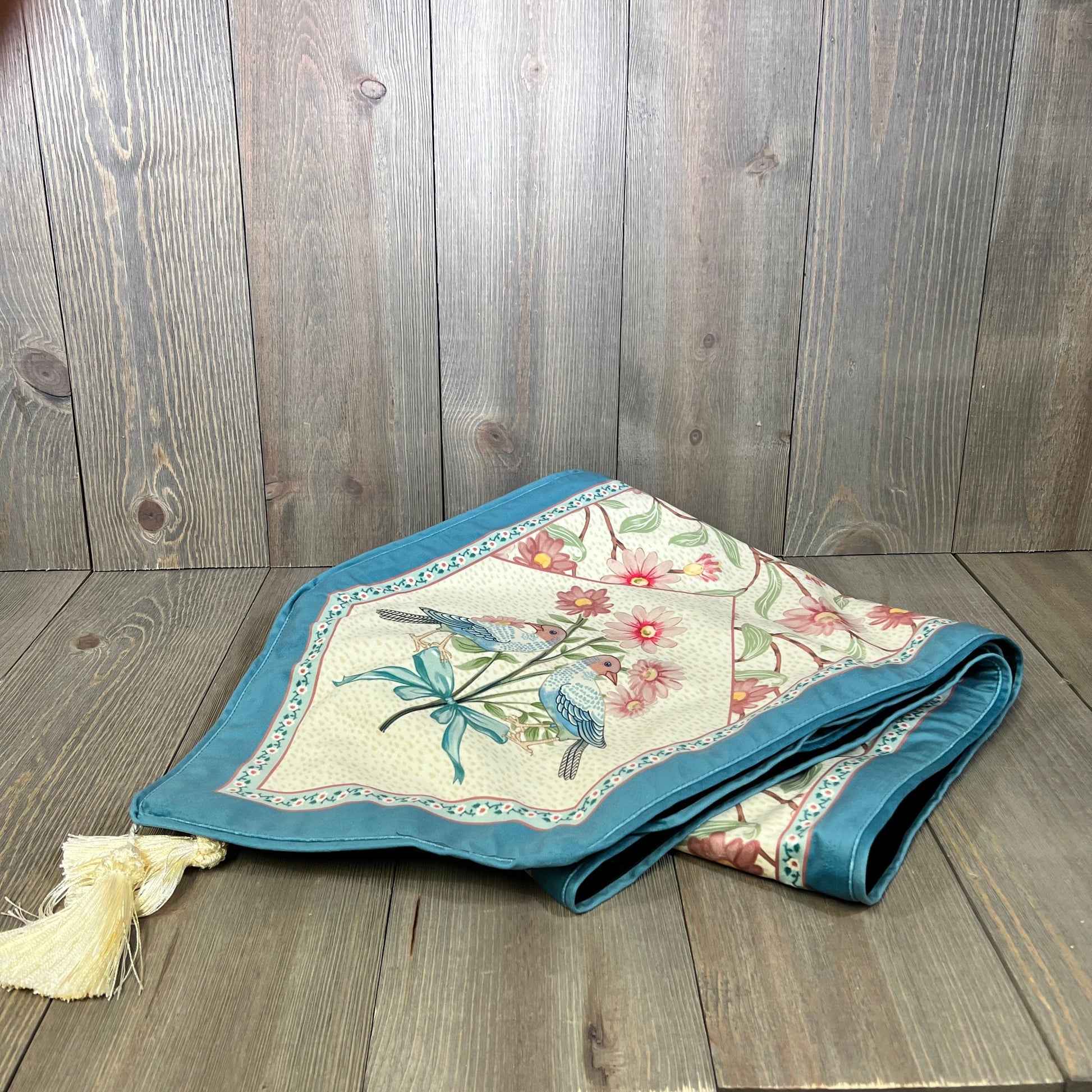 Elegant beige pink floral velvet table runner with tassels, showcasing wildflower design, perfect for dining or coffee tables.