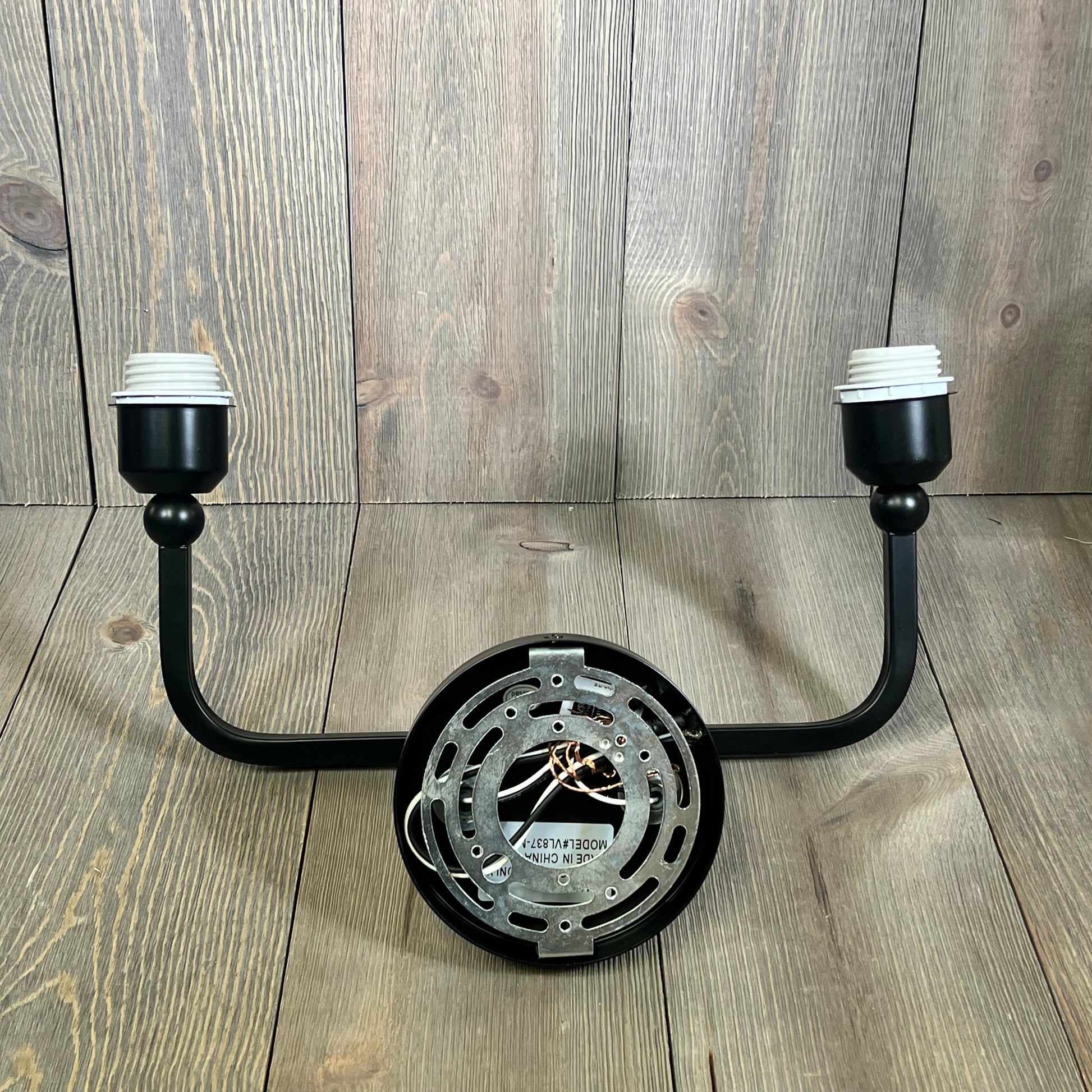 Modern matte black 2-light bathroom vanity fixture with a sleek design, ideal for contemporary spaces.