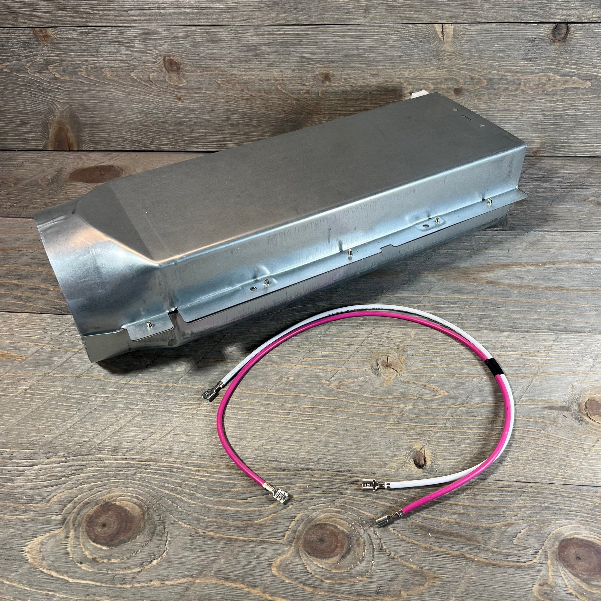 Dryer heating element assembly with wires for LG models, showcasing durable construction on wooden background.